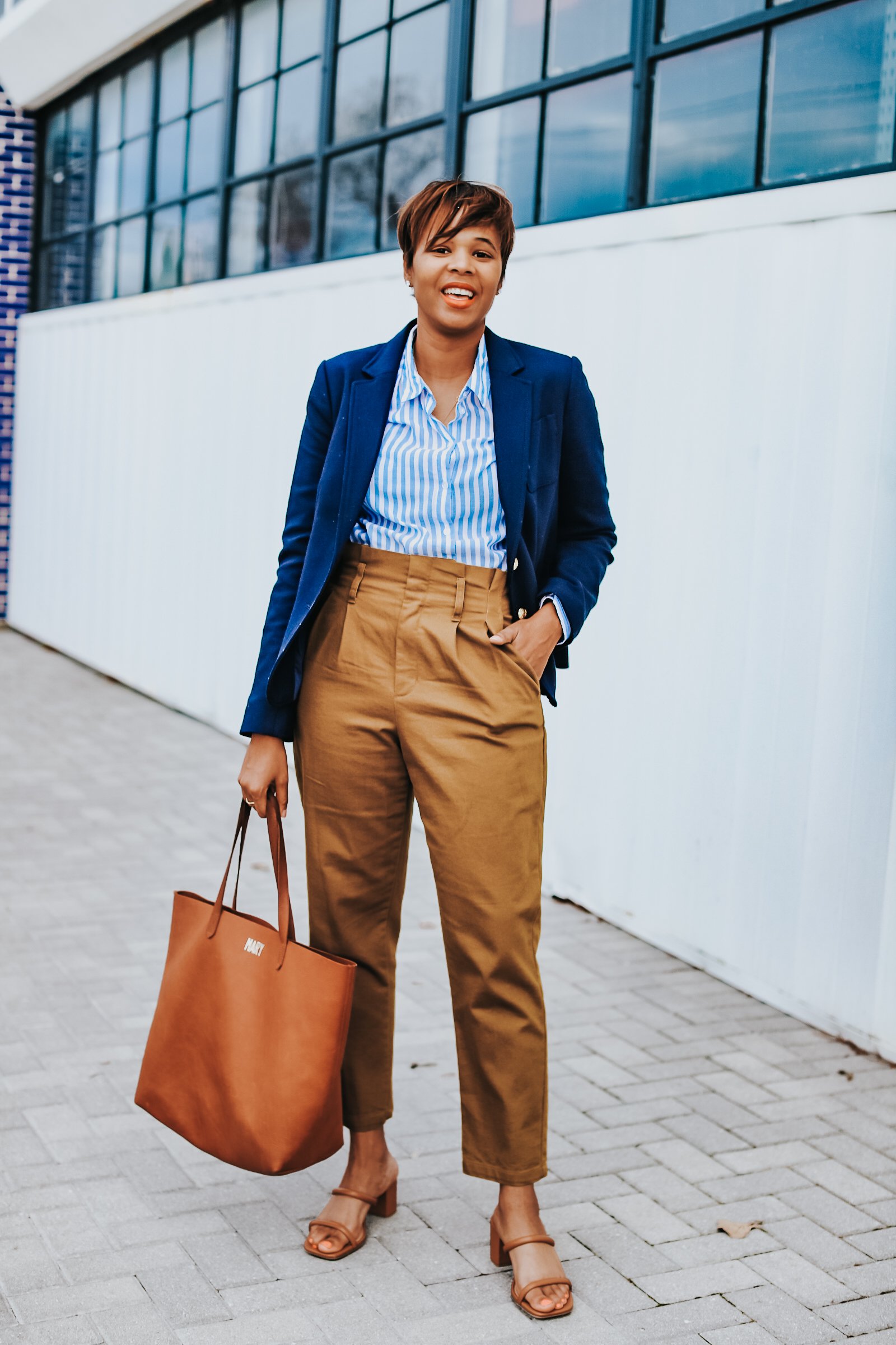 Mary's Little Way in A Navy Blazer, a Blue and White Striped Boyfriend Shirt, Mustard Yellow Paperboy Pants, and Brown Block Heels
