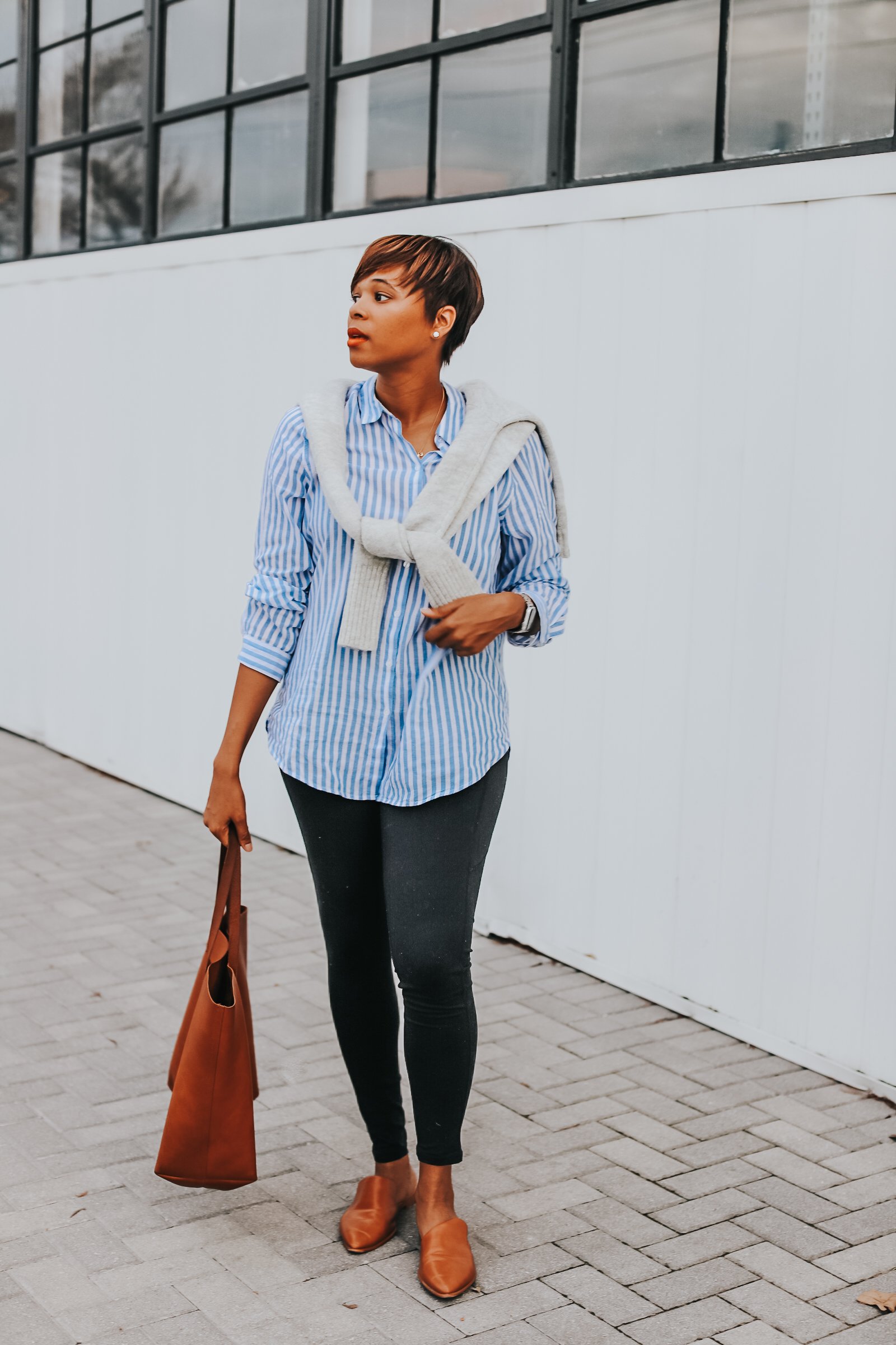 Mary's Little Way in A Gray Knotted Sweater, a Blue and White Striped Boyfriend Shirt, Tan Mules, and Tan Tote bag