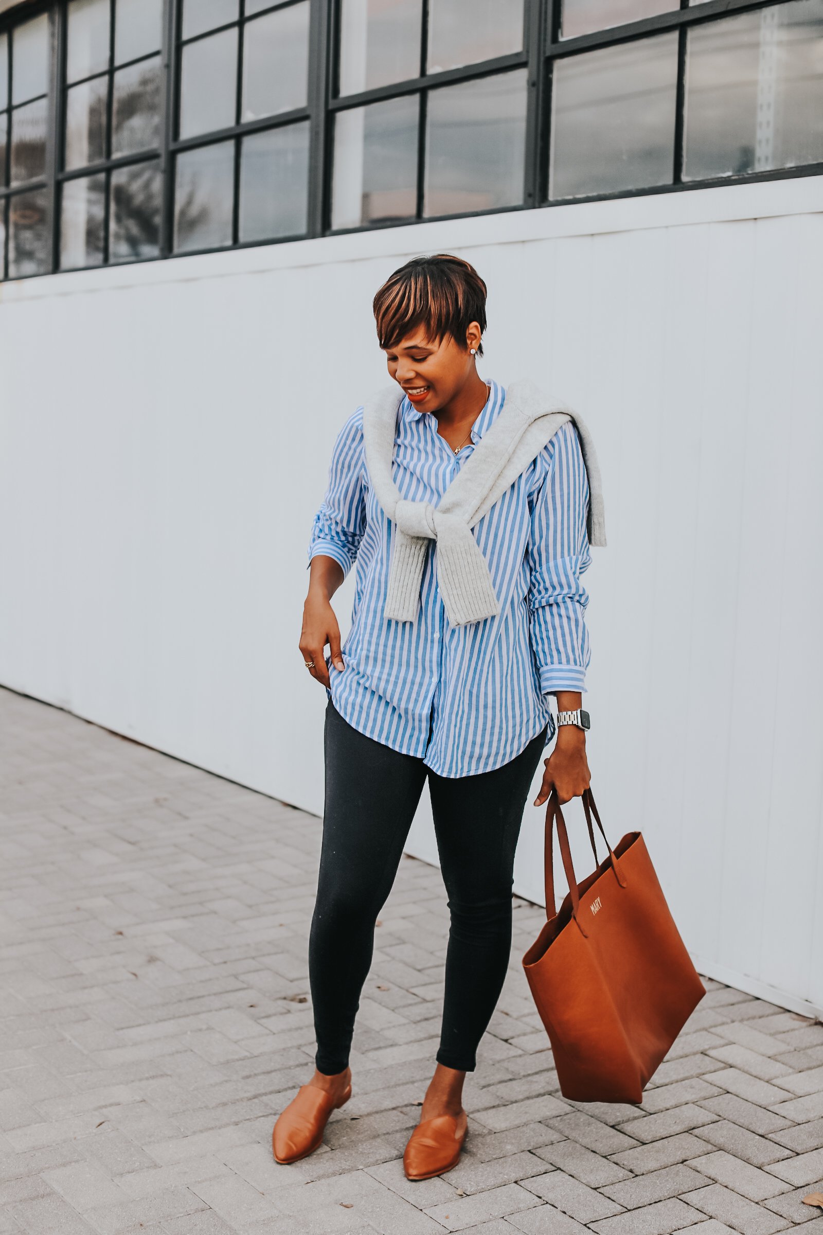 Mary's Little Way in A Gray Knotted Sweater, a Blue and White Striped Boyfriend Shirt, Tan Mules, and Tan Tote bag