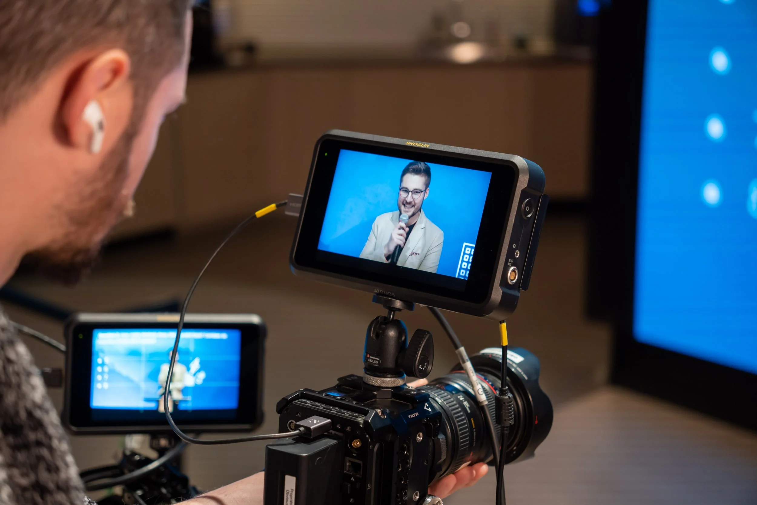 Nicholas Belliveau presenting on stage at a technology conference