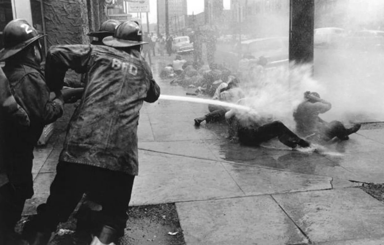 The Birmingham Fire Department uses powerful hoses, specifically designed to fight fires, to spray human beings exercising their right to protest. (1963)