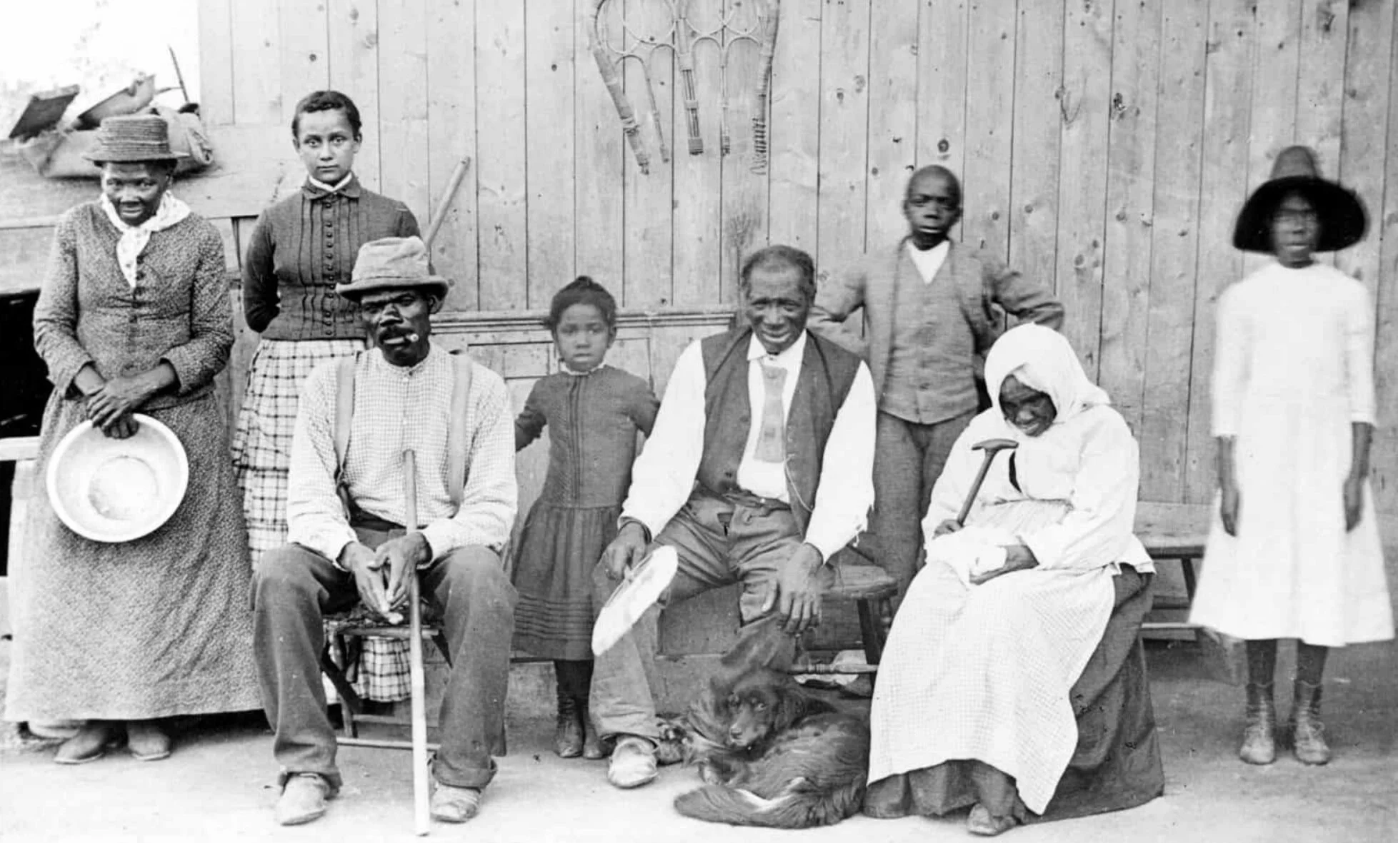 To the far left is abolitionist, Harriet Tubman, pictured with former enslaved persons she helped escort to freedom. (c. 1885)