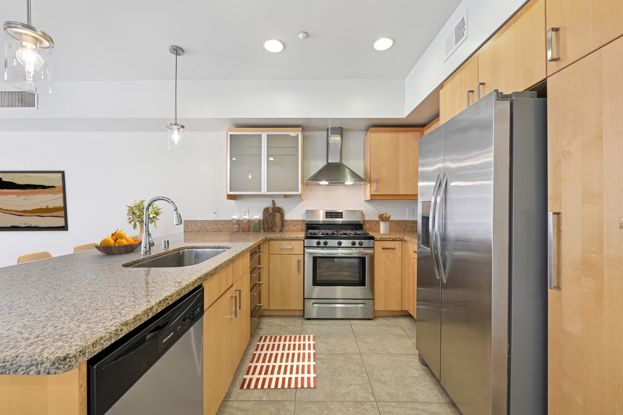 This is a photo of a two-bedroom apartment unit at M Sole. This image shows the spacious kitchen. 
