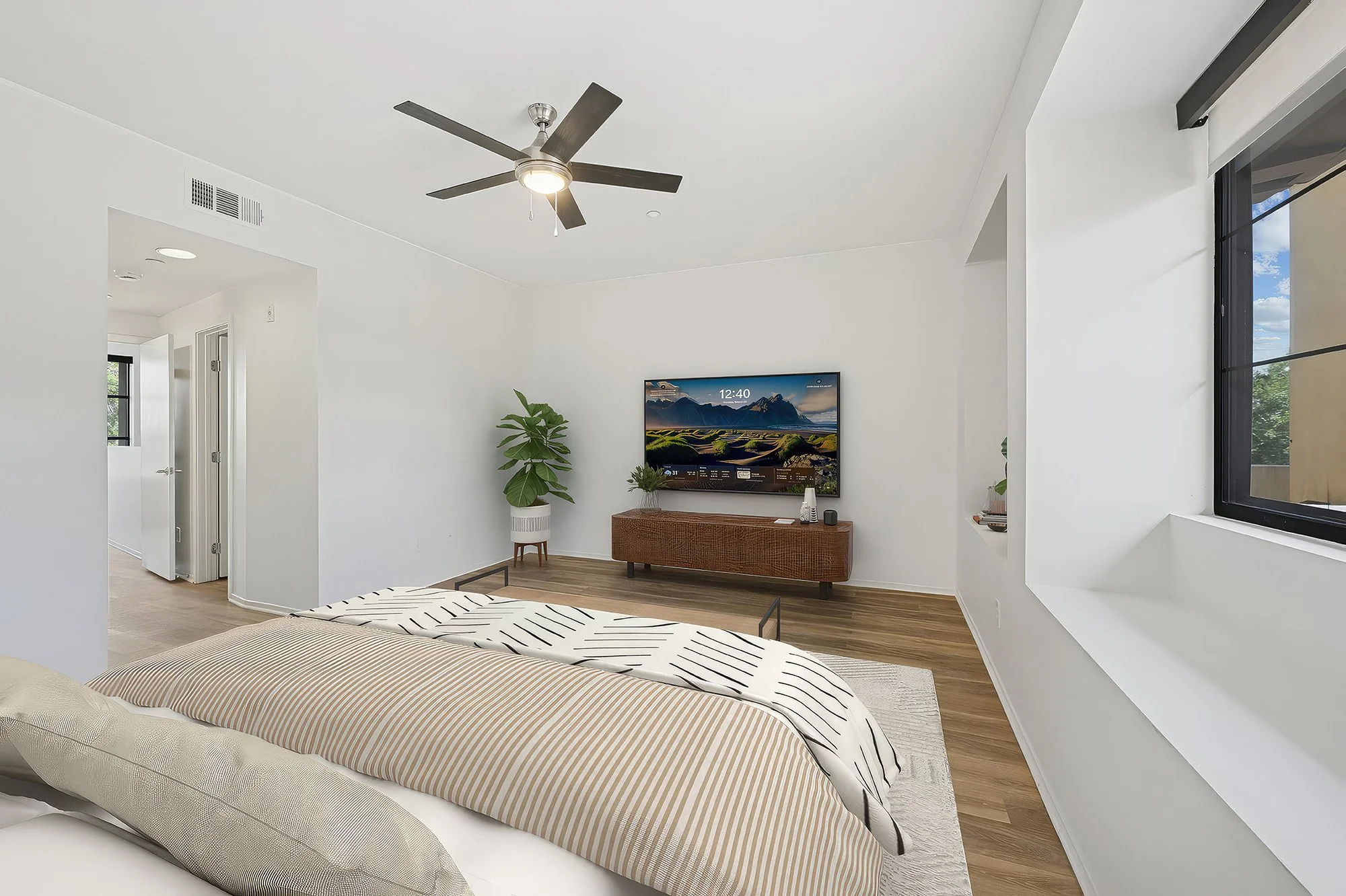 This is a photo of a two-bedroom apartment unit at M Sole. This image shows the cozy primary bedroom. 