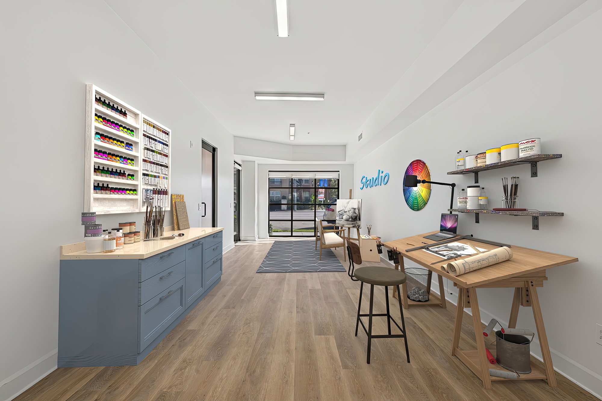 This is a photo of a two-bedroom apartment unit at M Sole. This image shows the downstairs workspace set up as a paint studio. 