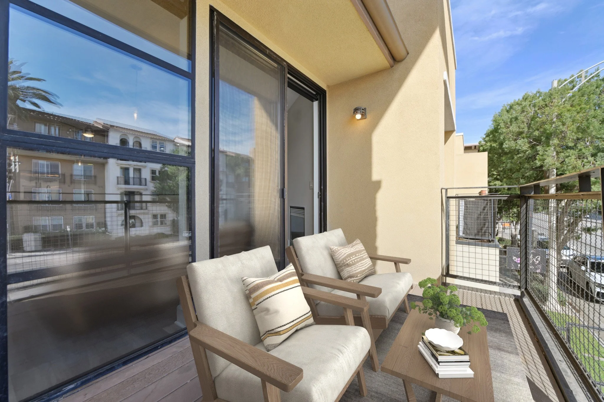 This is a photo of a two-bedroom apartment unit at M Sole. This image shows the balcony sitting area.