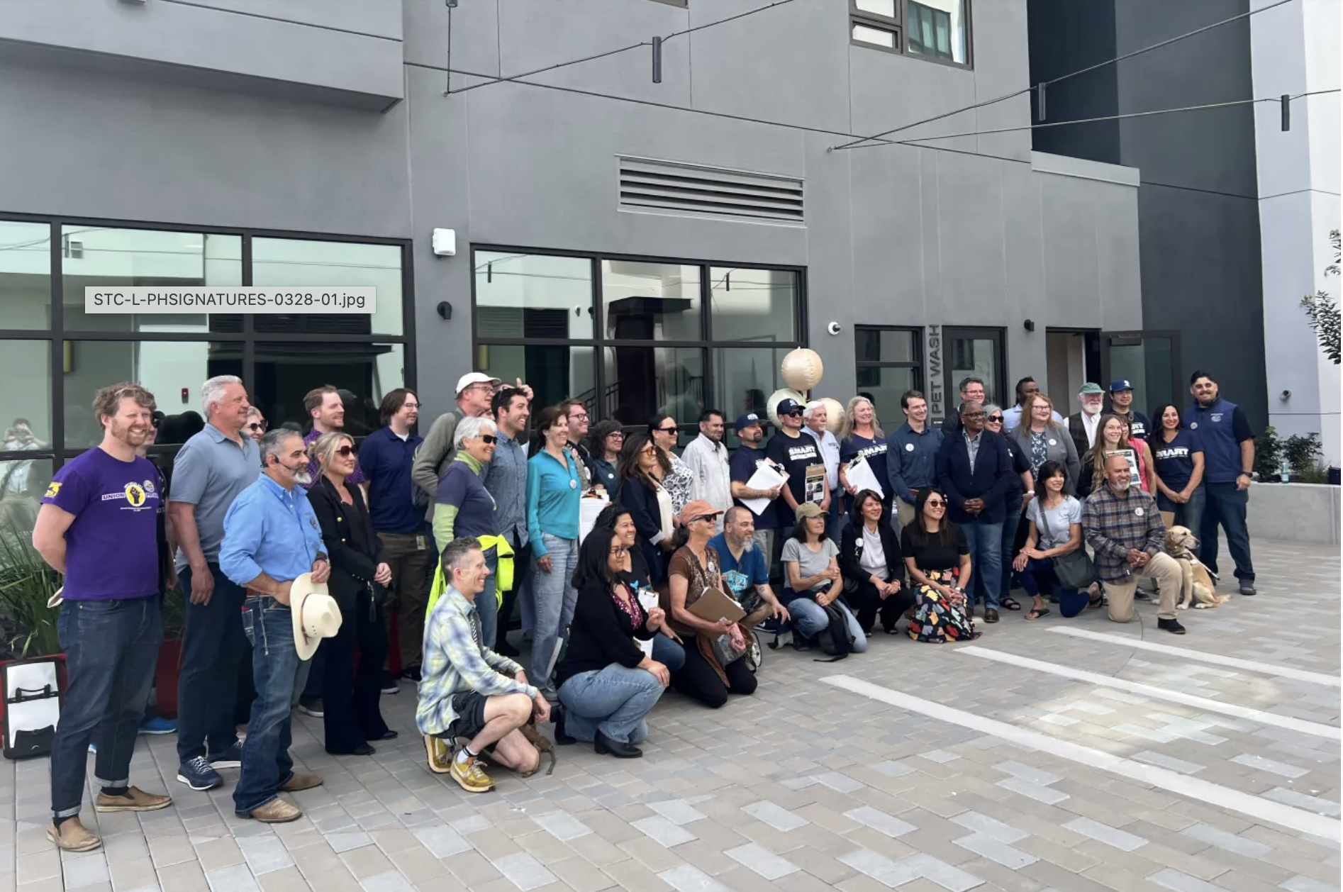 Supporters of a citizens initiative seeking to pass a half-cent countywide sales tax increase that will continue to power ongoing Santa Cruz Metro operations and expand free ride programs pose for a photo at an event Friday. (PK Hattis — Santa Cruz S
