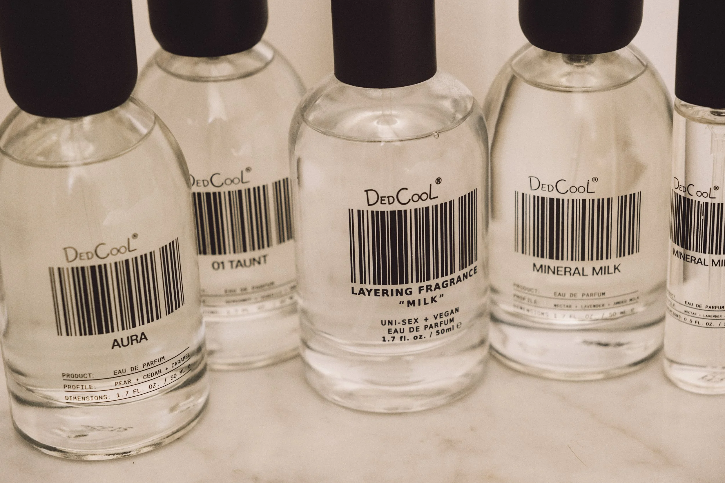 bottles of dedcool milk perfume
