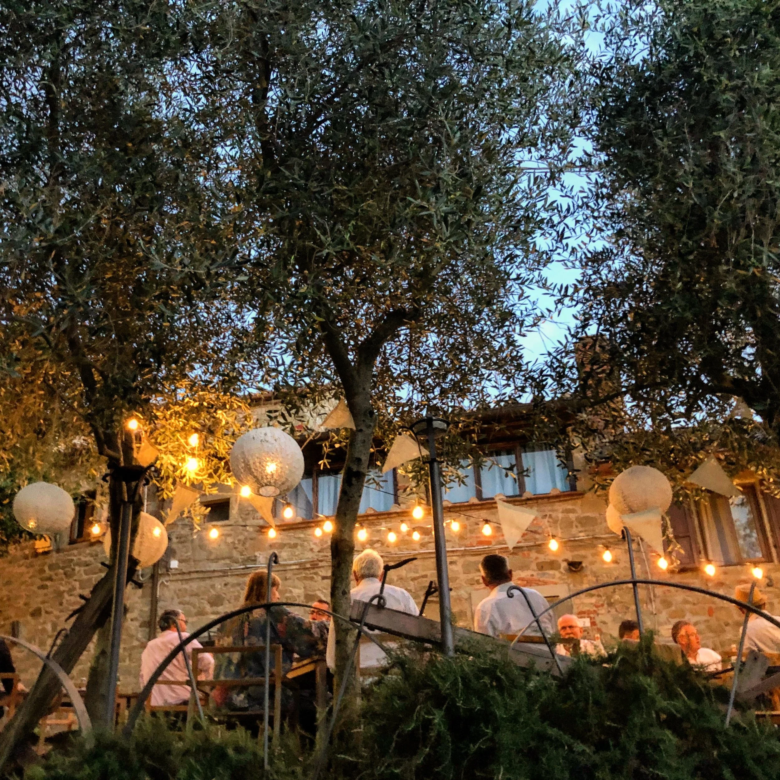 An outdoor wedding at dusk at Castello di Ristonchi near Florence Italy.