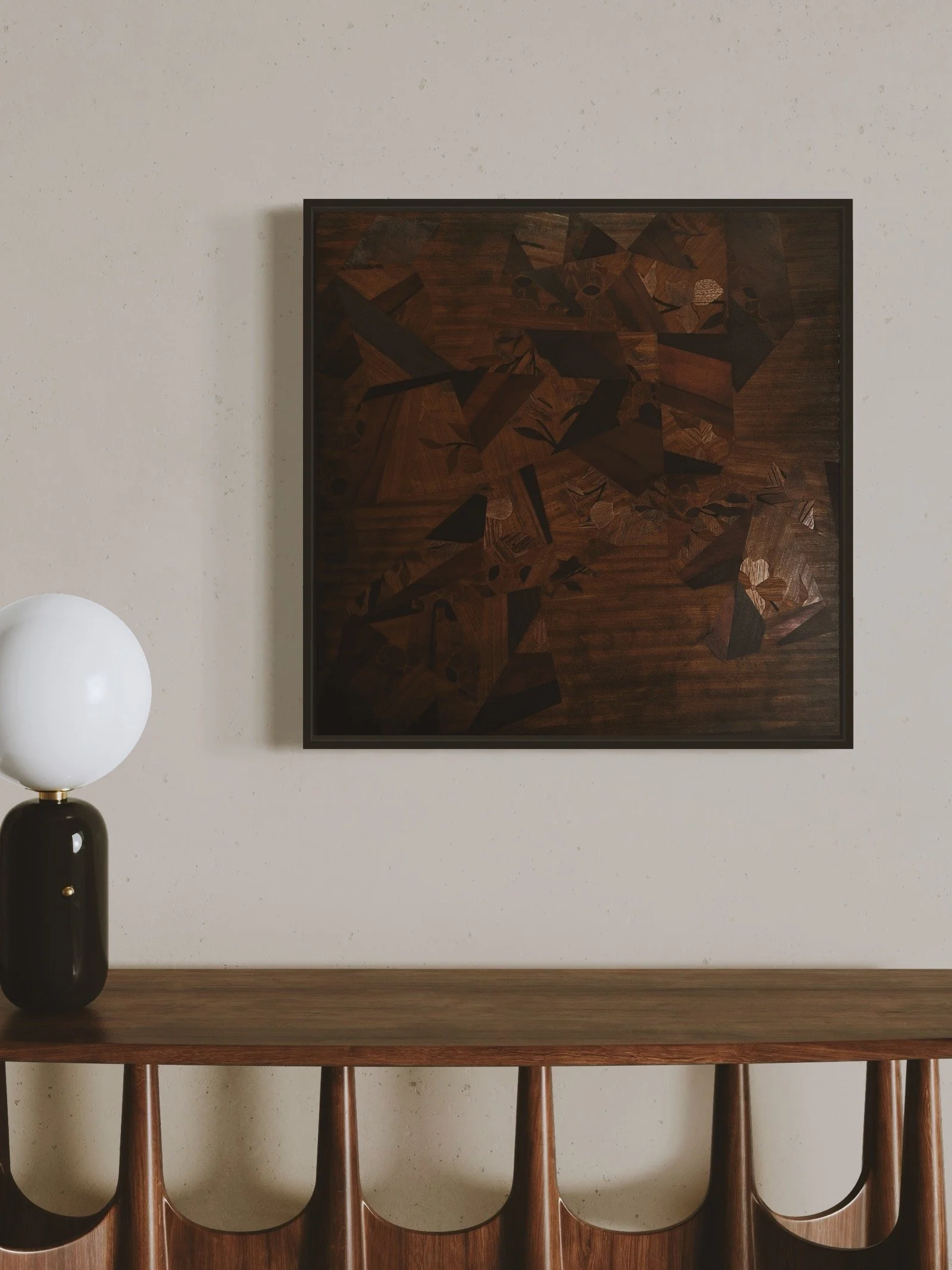 A minimalist interior scene featuring a dark wooden console table with carved details, a black and white modern lamp with a round white globe, and a wall-mounted abstract parquetry wooden art piece.