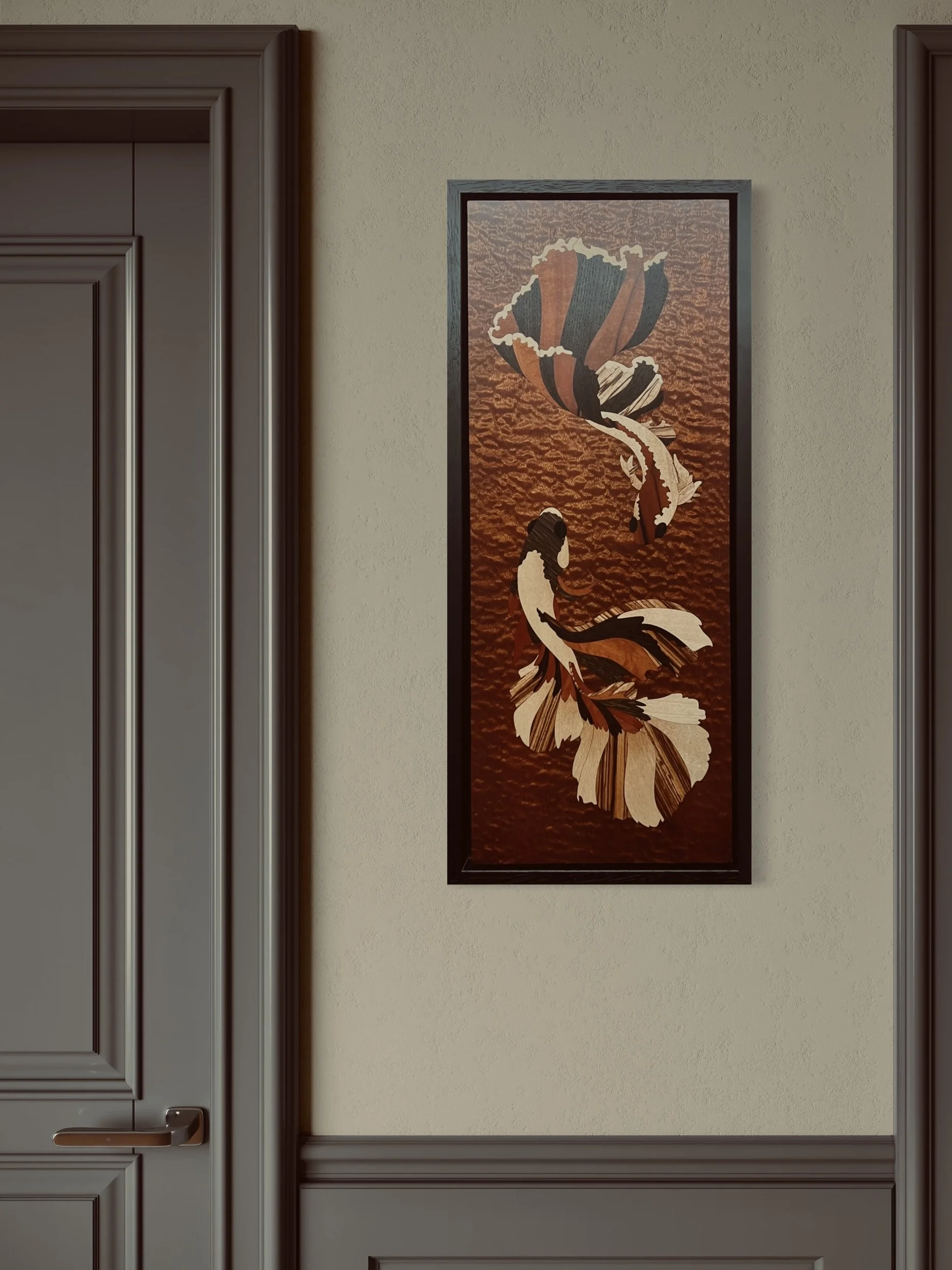 Vertical framed marquetry artwork of two koi fish swimming in water, mounted on a beige wall between two brown doorframes. Created by Carl Fox