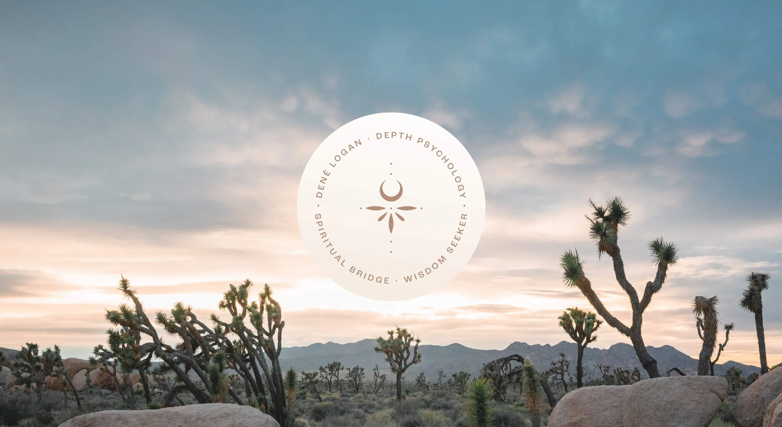 A desert landscape with twisted Joshua trees, large rocks, and mountains in the distance during sunset. A circular logo with a crescent moon and petal-like design overlays the sky, reading ‘Dené Logan, Depth Psychology, Spiritual Bridge, Wisdom Seeke