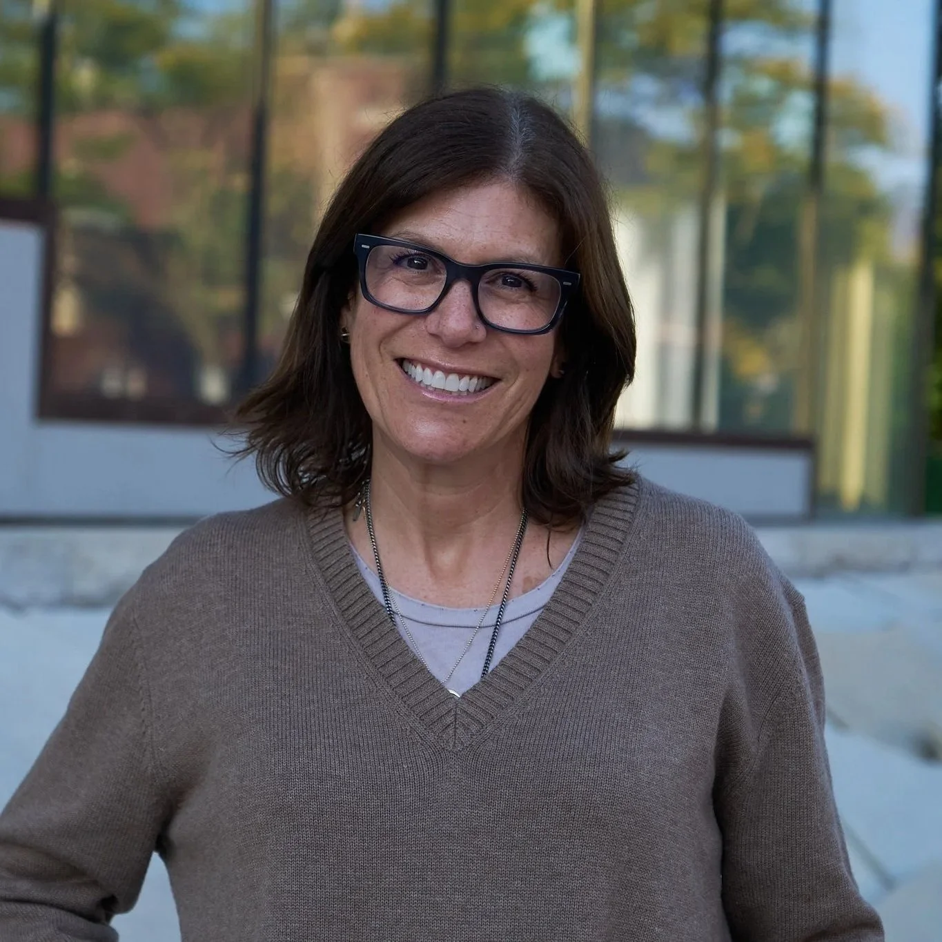 Woman with brown hair who is an Intuitive Healer smiling
