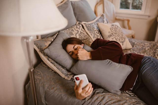 Woman staring at phone while waiting for a message, reflecting inconsistent effort in relationships — Wilson Counseling in Bellaire, Texas