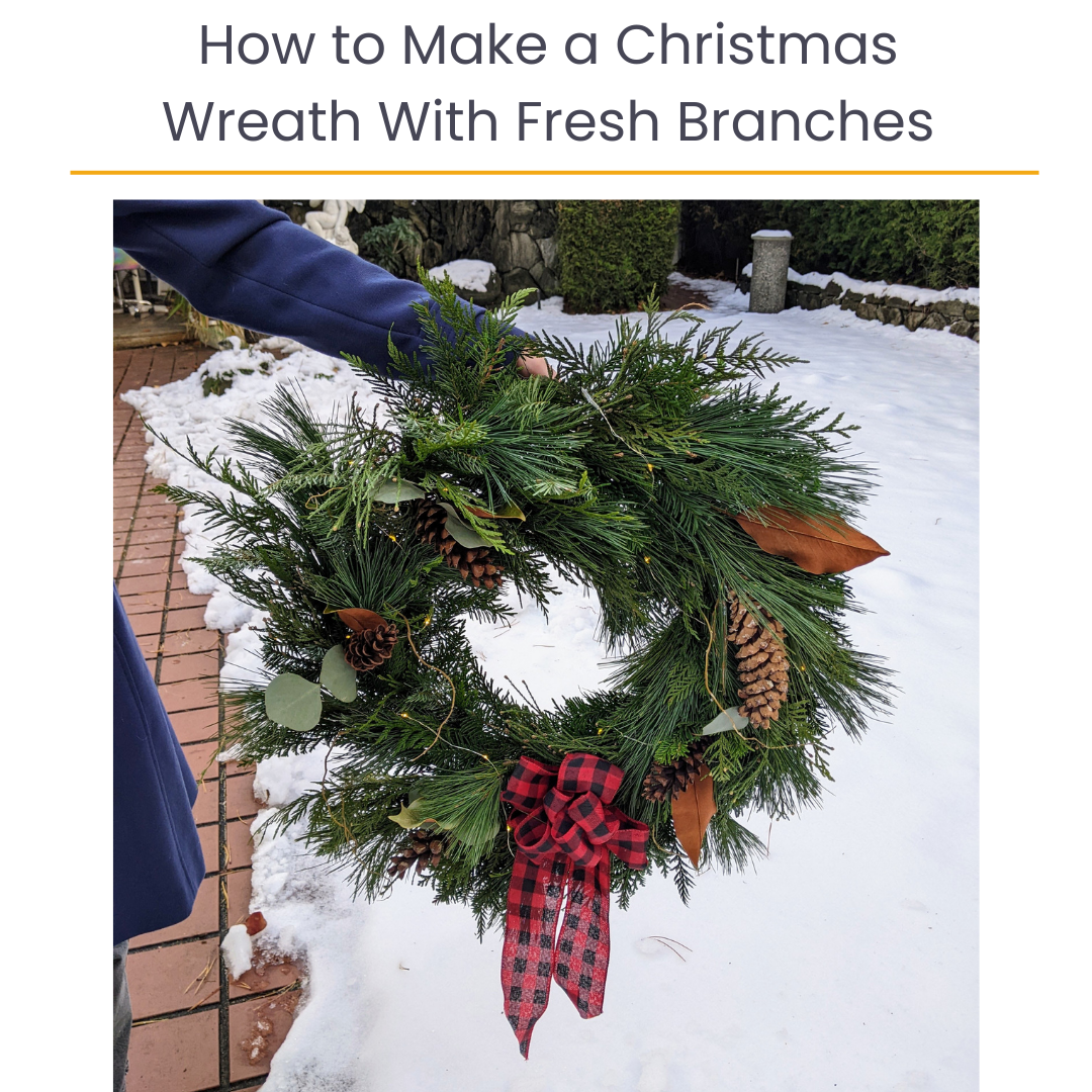 Person holding a Christmas wreath made of evergreen branches, pinecones, and leaves, decorated with a red and black plaid bow, on a snow-covered outdoor area. Text over top reads, "How to Make a Christmas Wreath With Fresh Branches."