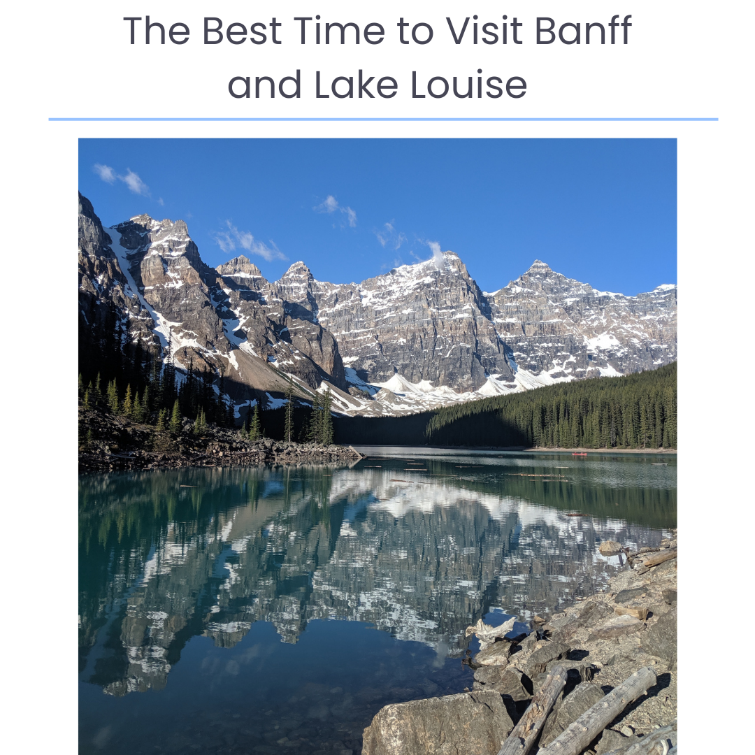 Scenic view of snow-capped mountains reflecting in a calm lake with pine trees along the shoreline and a clear blue sky. Text over top reads, "The Best Time to Visit Banff and Lake Louise."