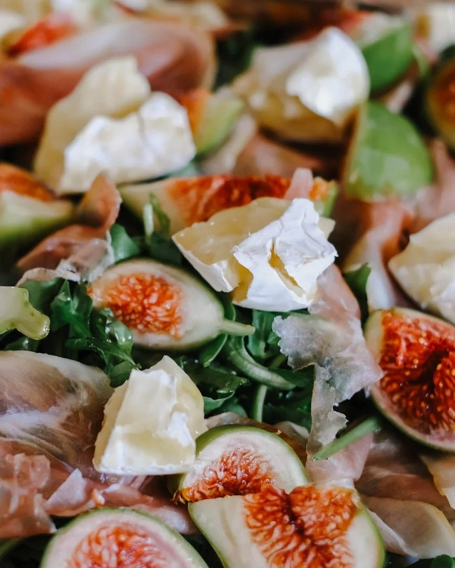 A summer salad we approve! Made with our Triple Cream Brie, fresh figs, and prosciutto on a bed of rocket. Top it with a drizzle of honey and olive oil dressing and your taste buds will thank you!