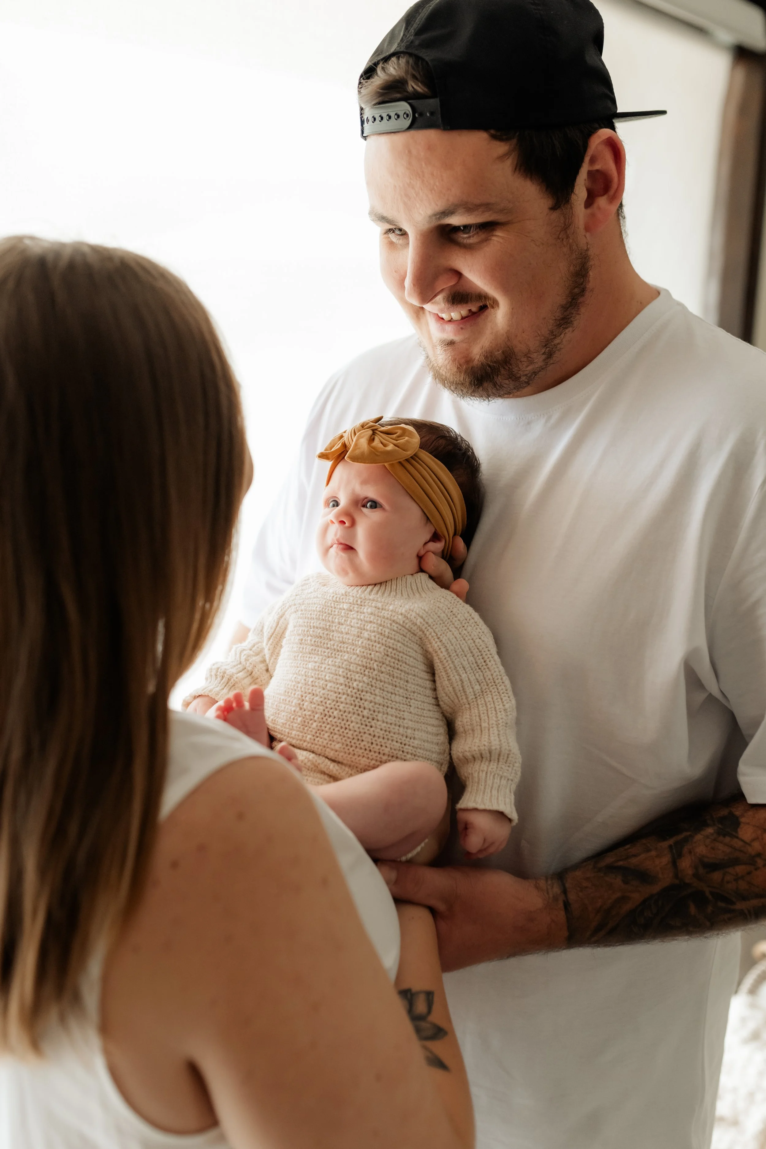 logan newborn photographer baby next to window