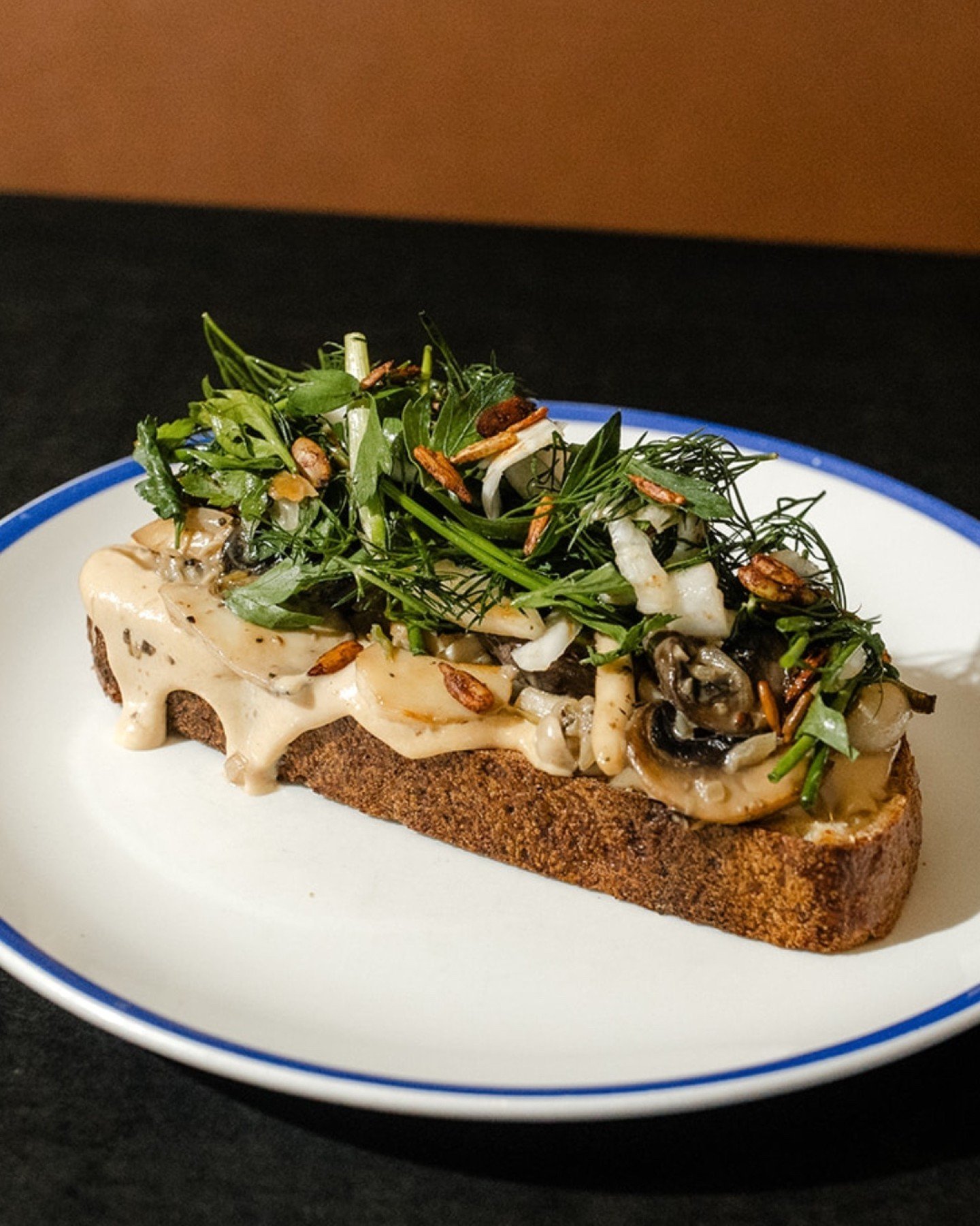 The saut&eacute;ed mushroom medley on the Mushroom Tartine is something else. It's breakfast, it's lunch, it's the perfect warm &amp; creamy flavours. Topped with a herb salad to freshen the palate.
