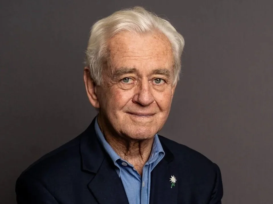 Keith Wilson, former Western Australian Minister for Health. Older man in a suit with white hair against a gray background