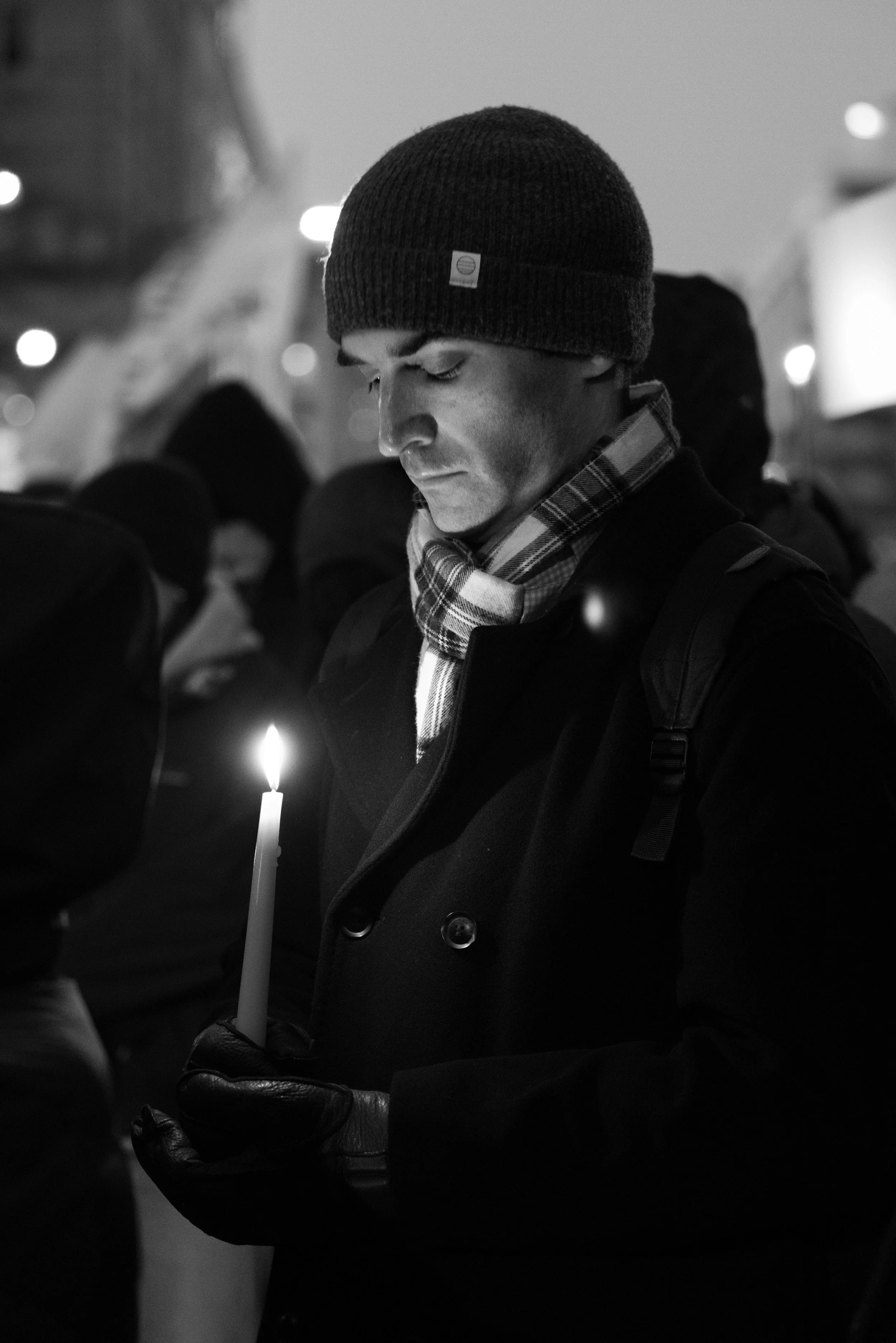 A demonstrator holds a candle at a vigil following the death of Alex Pretti. Pretti was shot and killed by ICE officers in Minneaopolis as they attempted to detain him.