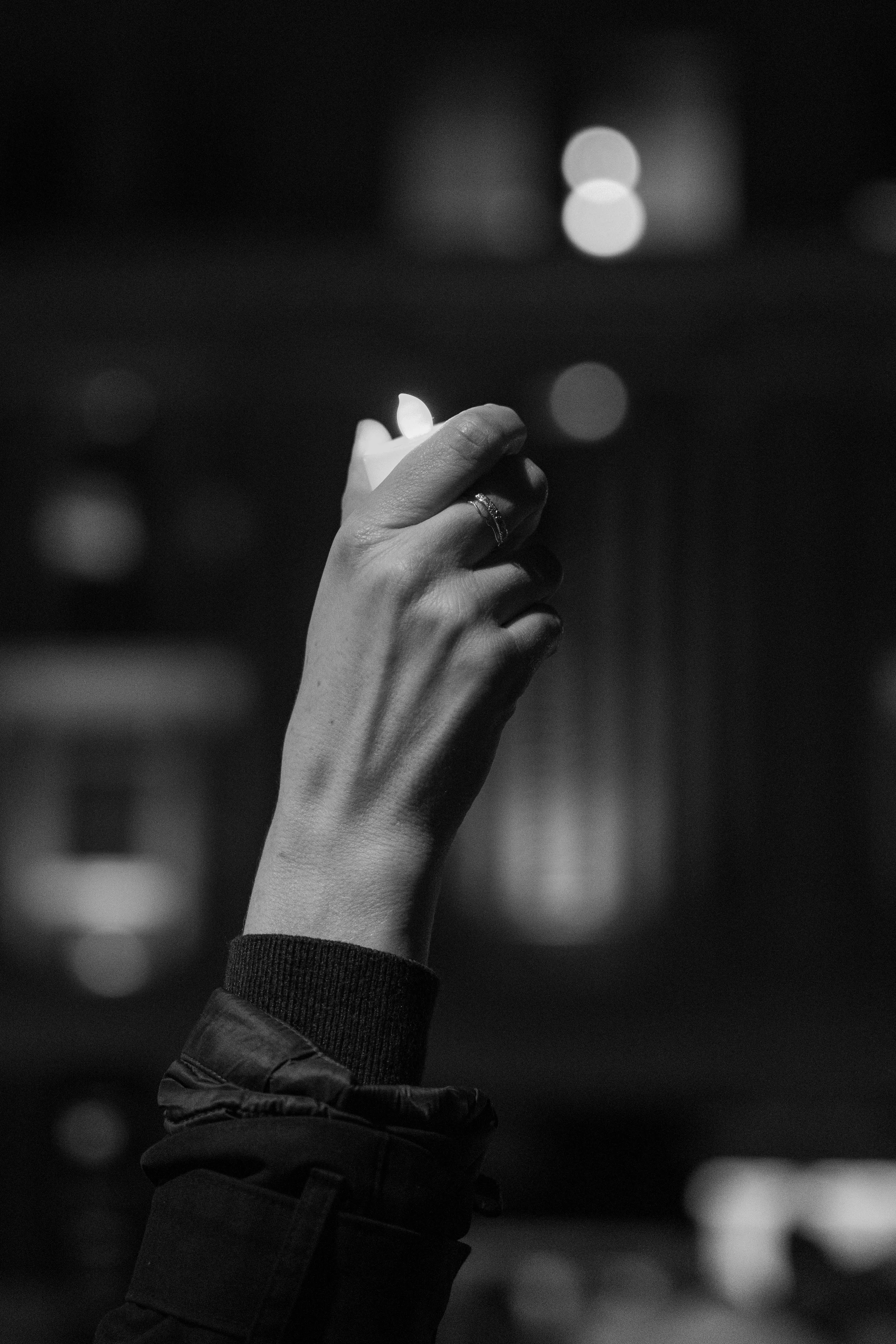 A demonstator holds a candle in rememberance of Alex Pretti. Pretti was shot and killed by ICE officers in Minneaopolis as they attempted to detain him.