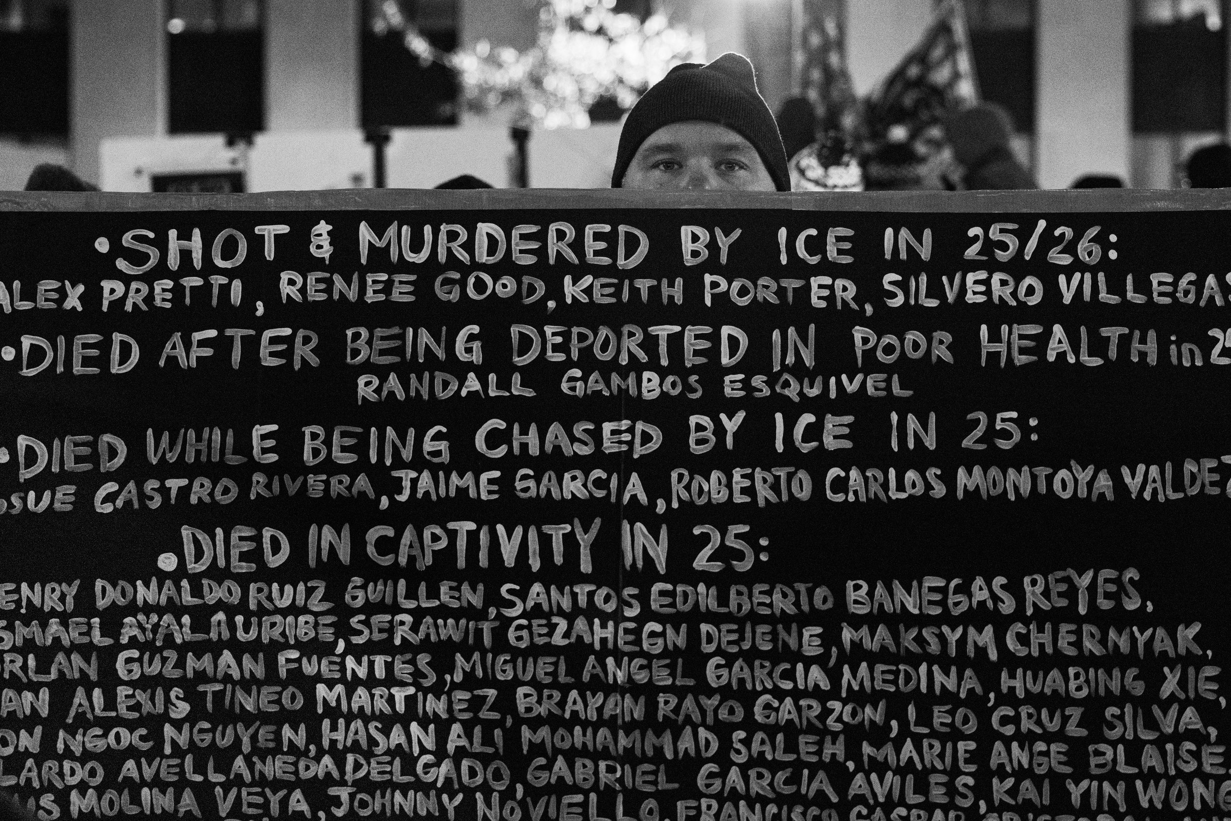 A demonstrator holds a sign at a vigil following the death of Alex Pretti. Pretti was shot and killed by ICE officers in Minneaopolis as they attempted to detain him.