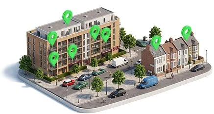 A 3D model of a residential area with a multi-story apartment building and smaller houses, parking spaces, and trees, with green location markers on various buildings.