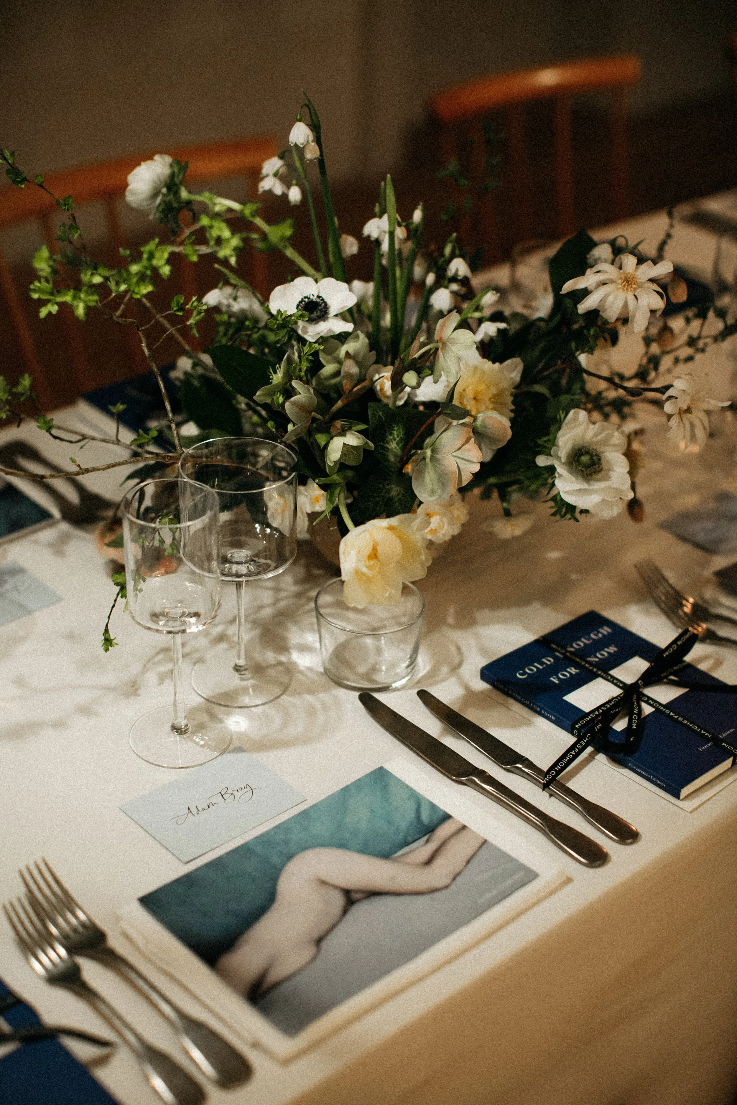 elegant table setting with floral centerpiece and wine glasses