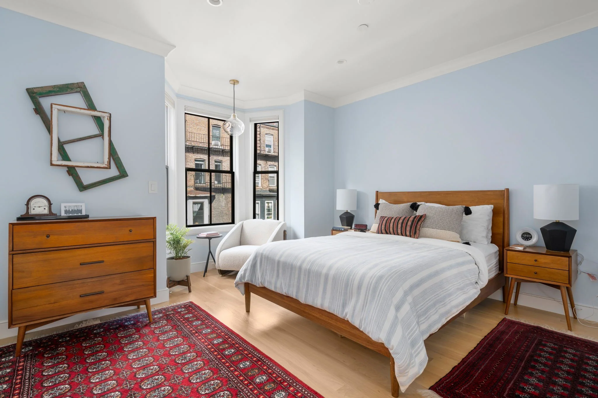From our 2023 South End Family Refresh Project, we made just a few minor tweaks to this bedroom to enhance this couples space.  We decluttered surfaces, added the cozy chair in the window to create a sun-filled reading nook, and added accent pillows.