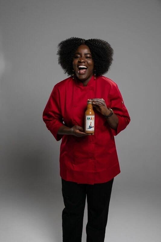 Chef Ouattara holding her original Akadi Mild sauce