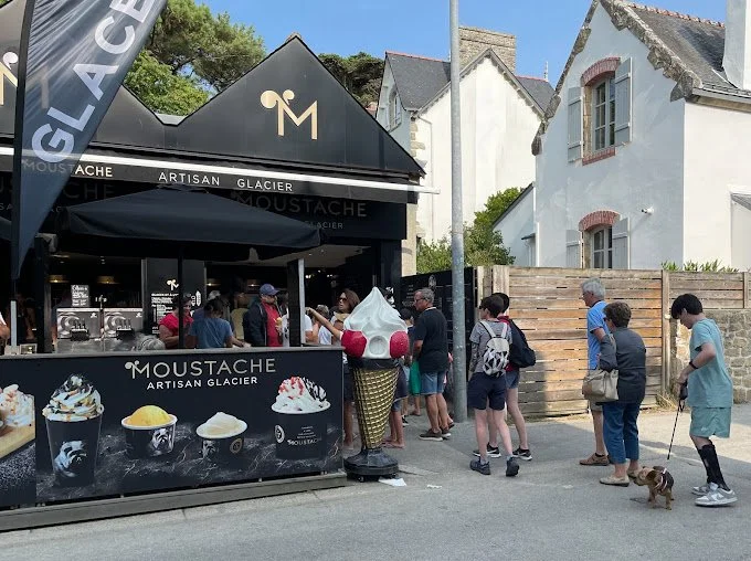 Customers outside the Moustache artisan ice-cream parlour in Carnac