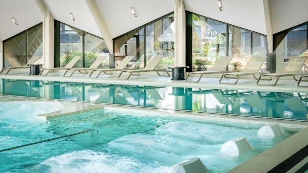 Heated indoor seawater pool beneath the floor-to-ceiling windows at Thalazur Carnac
