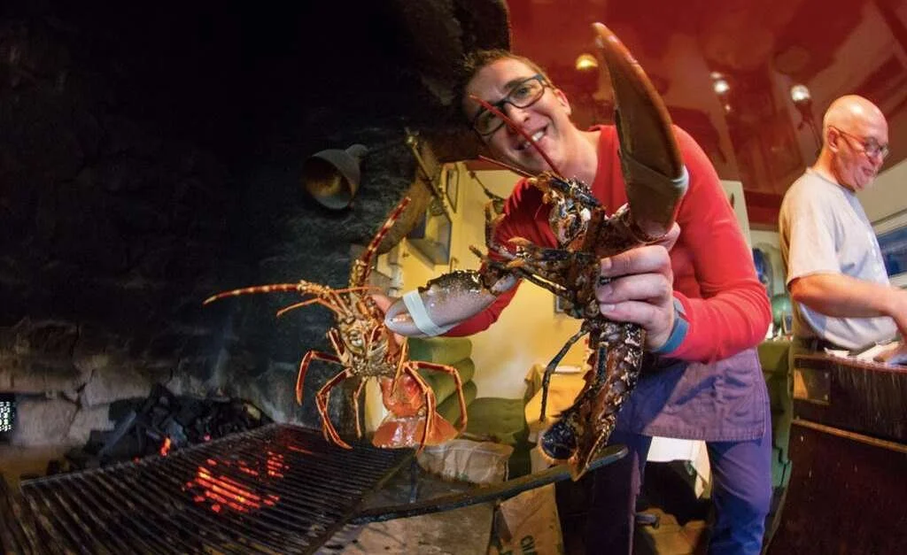 Lobsters and langoustines grilled over an open fire at La Calypso restaurant in Carnac