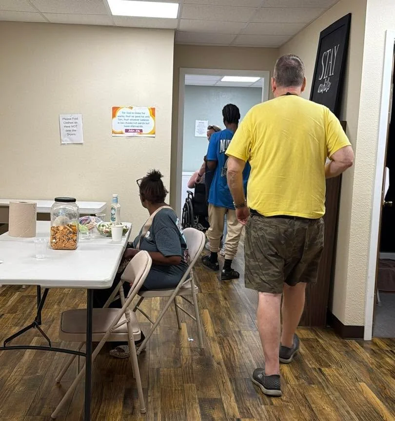Every day, people walk through our doors carrying different stories. Some are exhausted. Some are rebuilding. Some simply need someone to see them.

Our day room becomes a place to pause, connect, eat, rest, do laundry, receive resources, and take a 