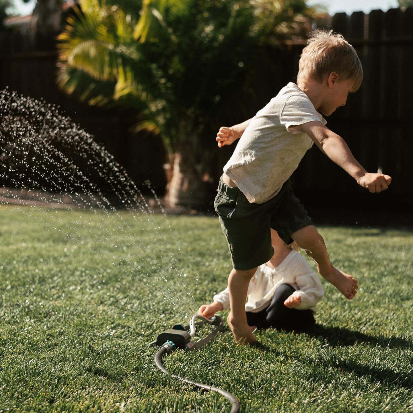 Nothing fancy. No perfect poses.
Just the kind of magic that happens when we slow down and let kids be kids.

Running wild through the sprinkler, barefoot and laughing &mdash; these are the grace-filled, fleeting moments that shape a childhood. And I