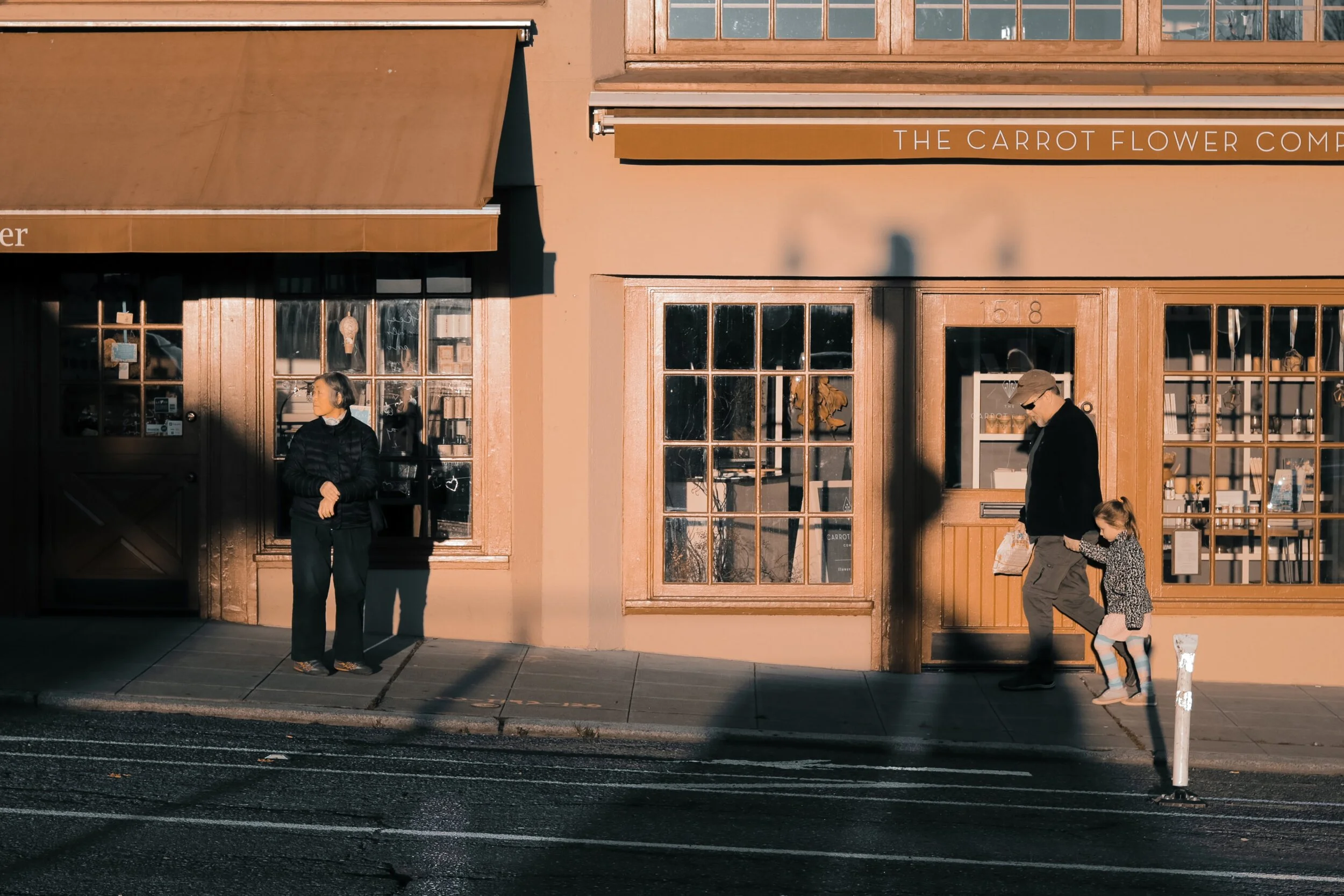 Image of storefront with an adult woman standing in front