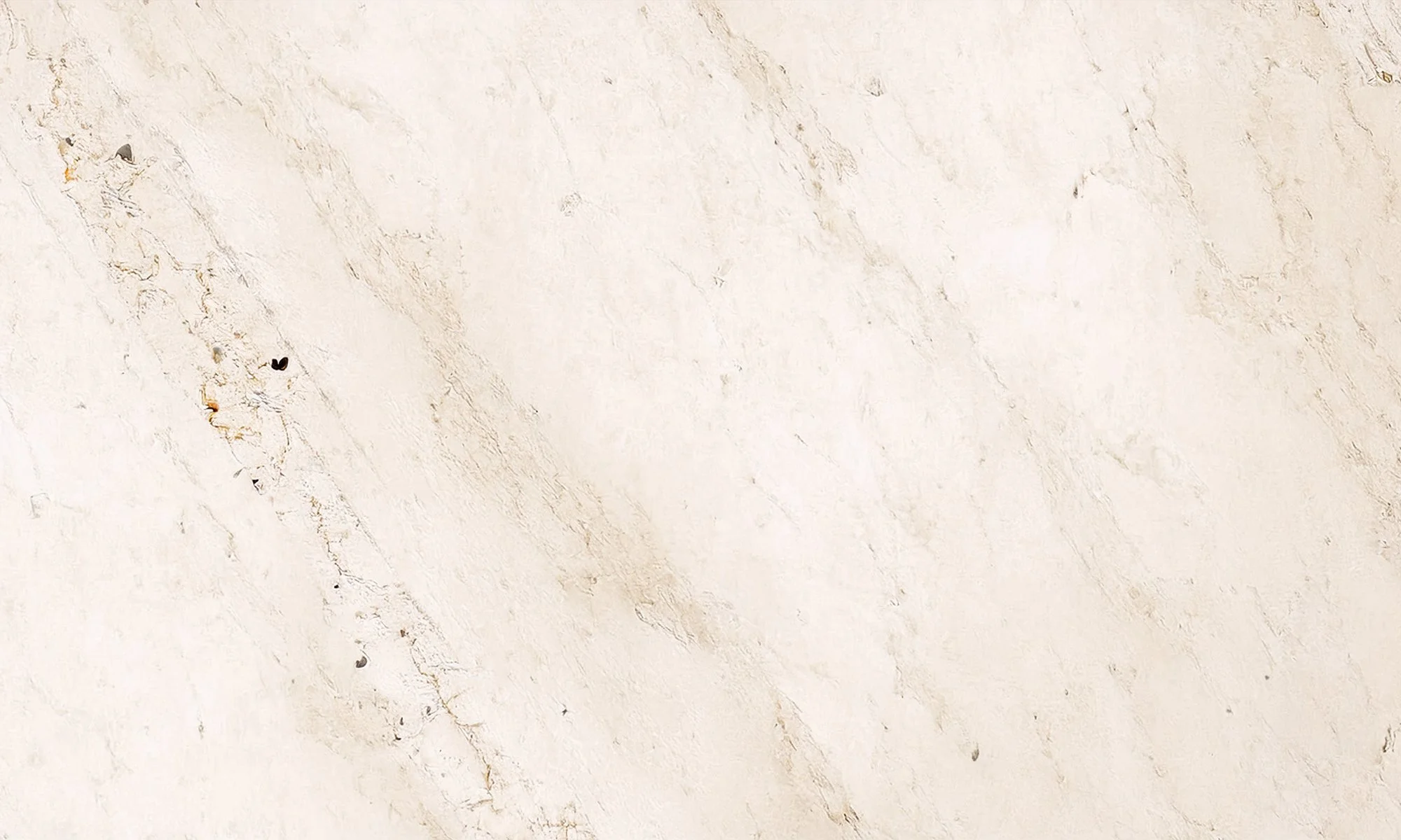 Close-up of a light-colored, textured marble surface with natural veins and imperfections.