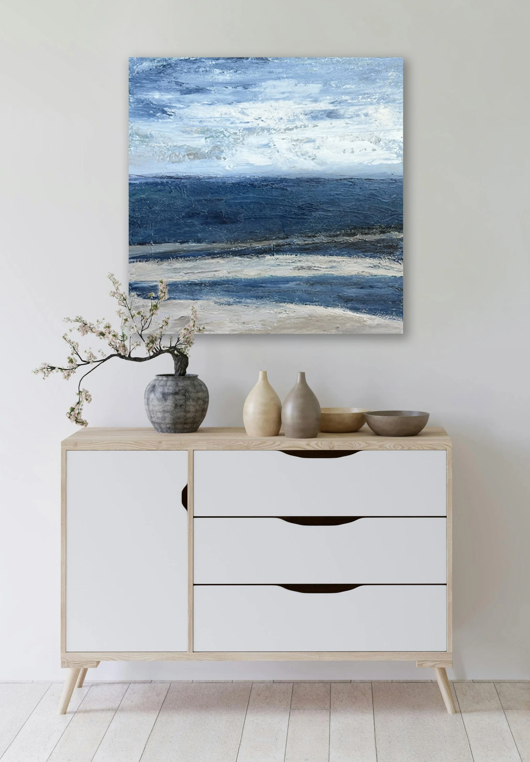 "Hilton Head Tide Pools" abstract coastal painting displayed above a cabinet, showing scale and presentation of the mixed media canvas artwork.