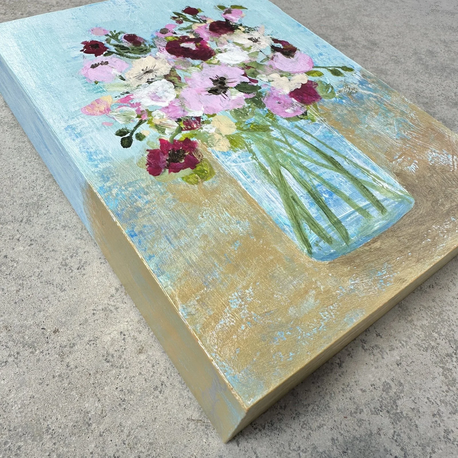 Side view deatil of pink flower painting on cradle board.
