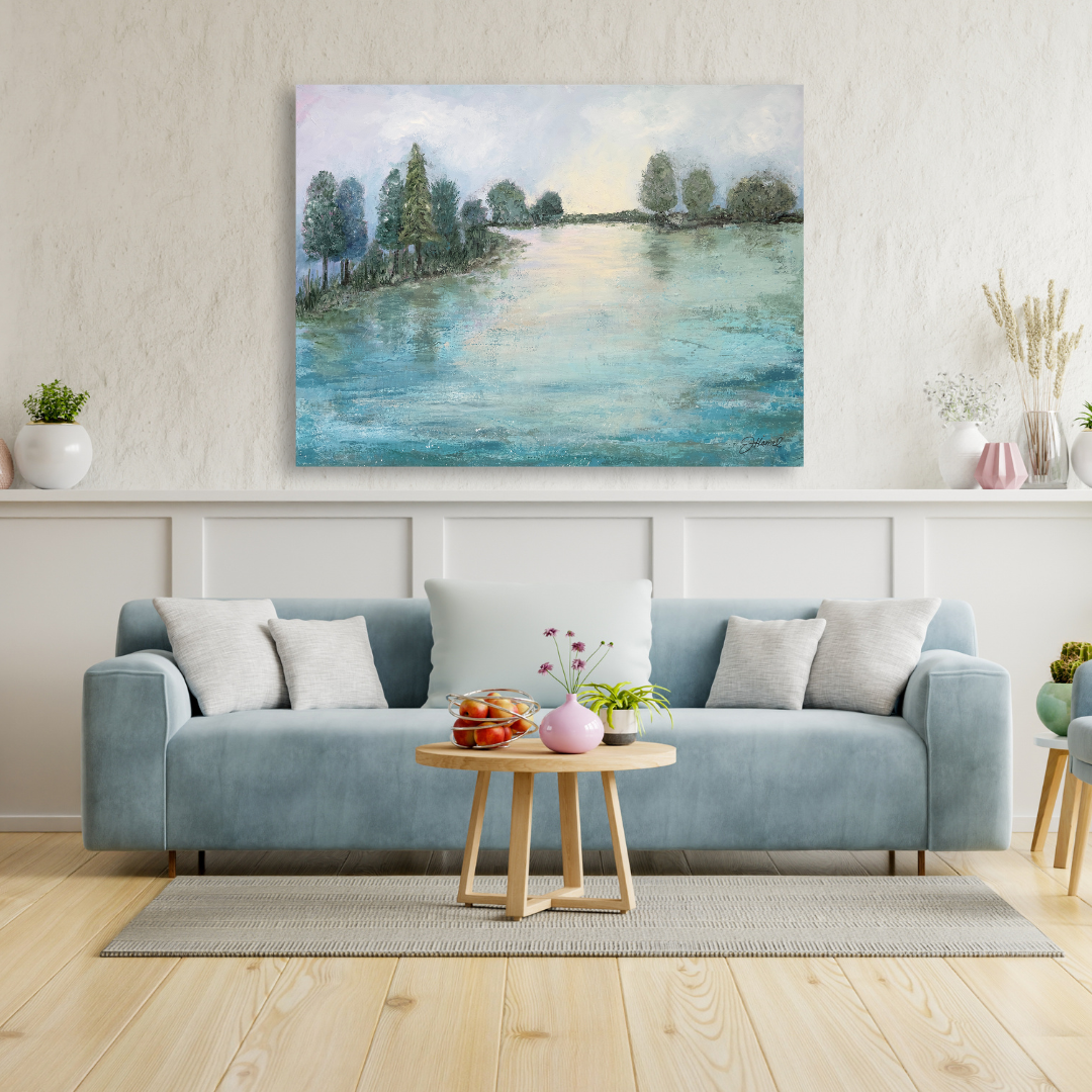 Large lake acrylic landscape painting displayed on a wall above a couch.