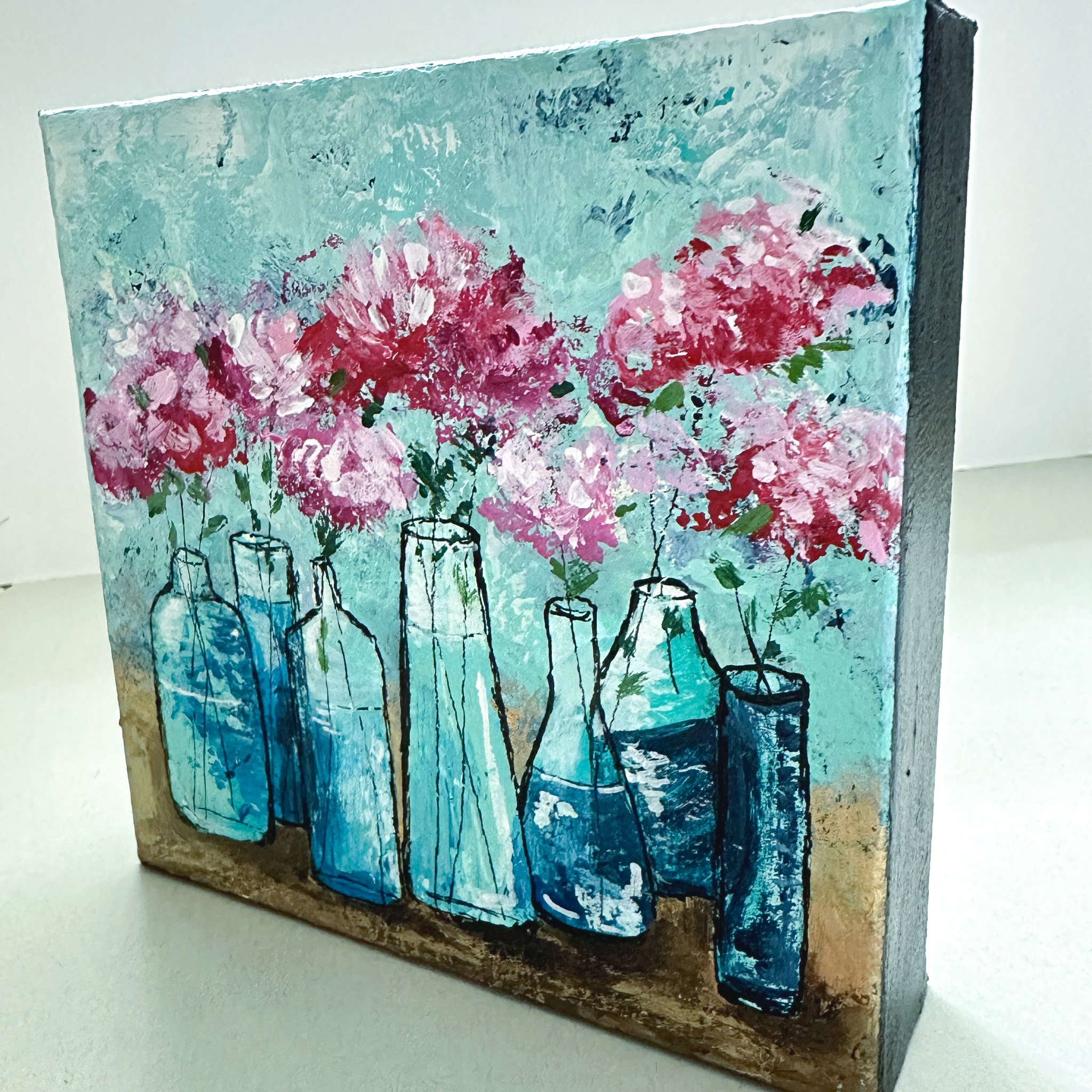 Side view of a pink floral painting.