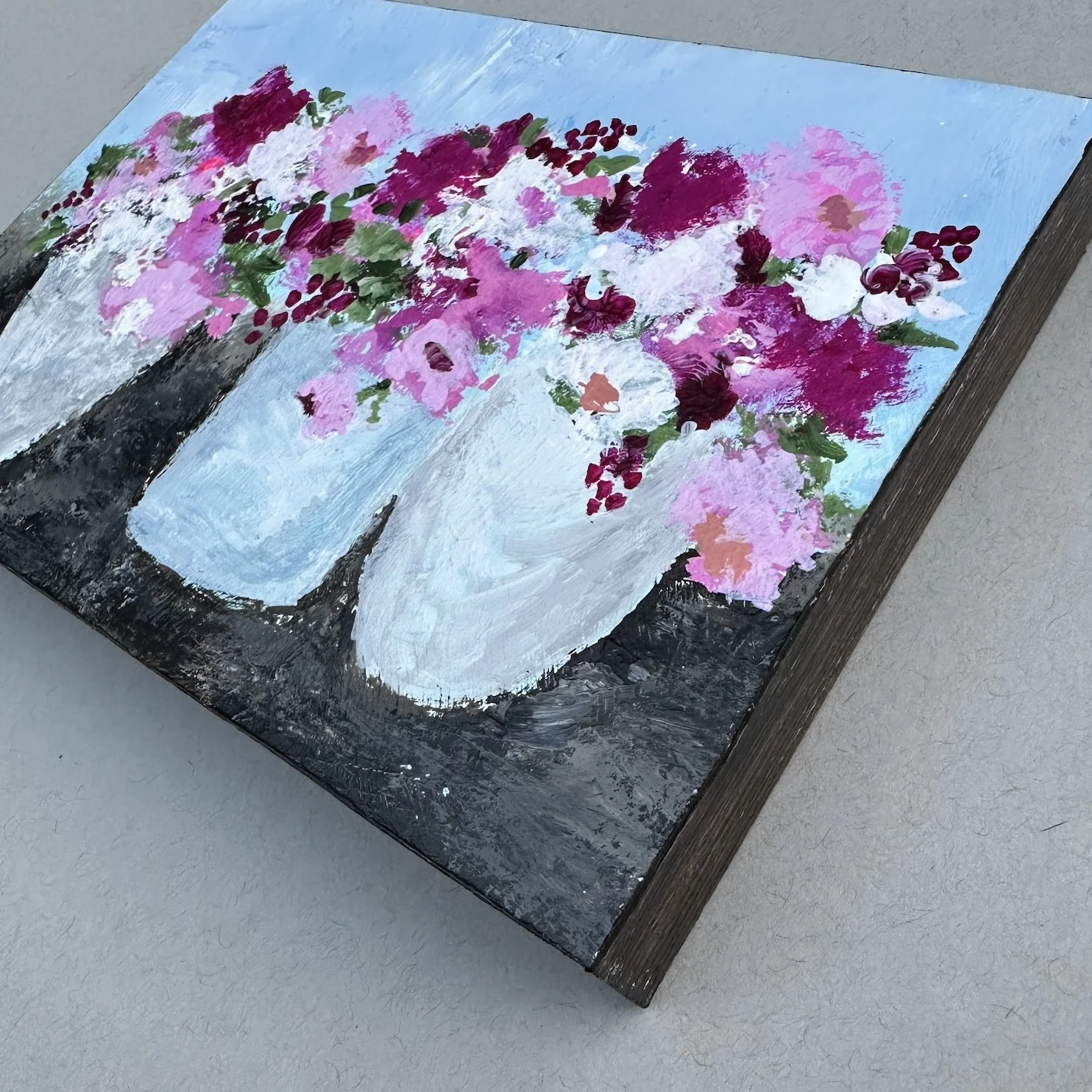 Painting side view of pink florals in porchside pots.