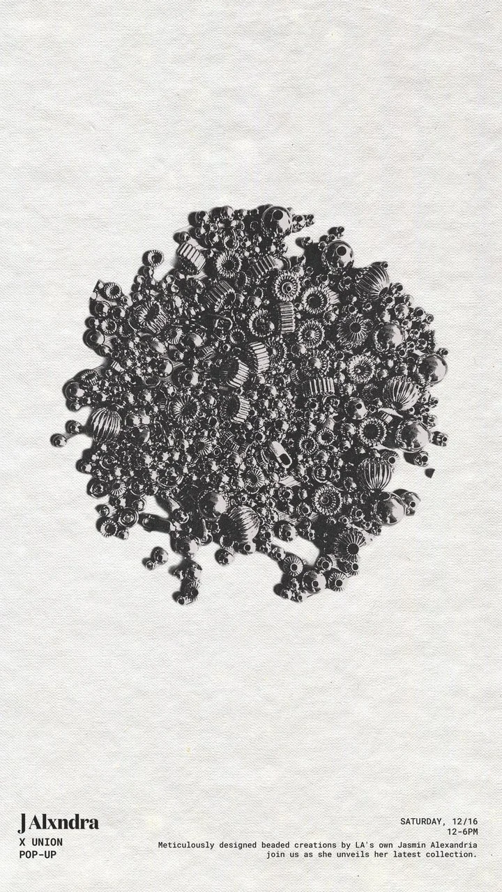 Black beaded jewelry pieces arranged in a circular shape on white fabric, with text describing a jewelry collection launch at the bottom.