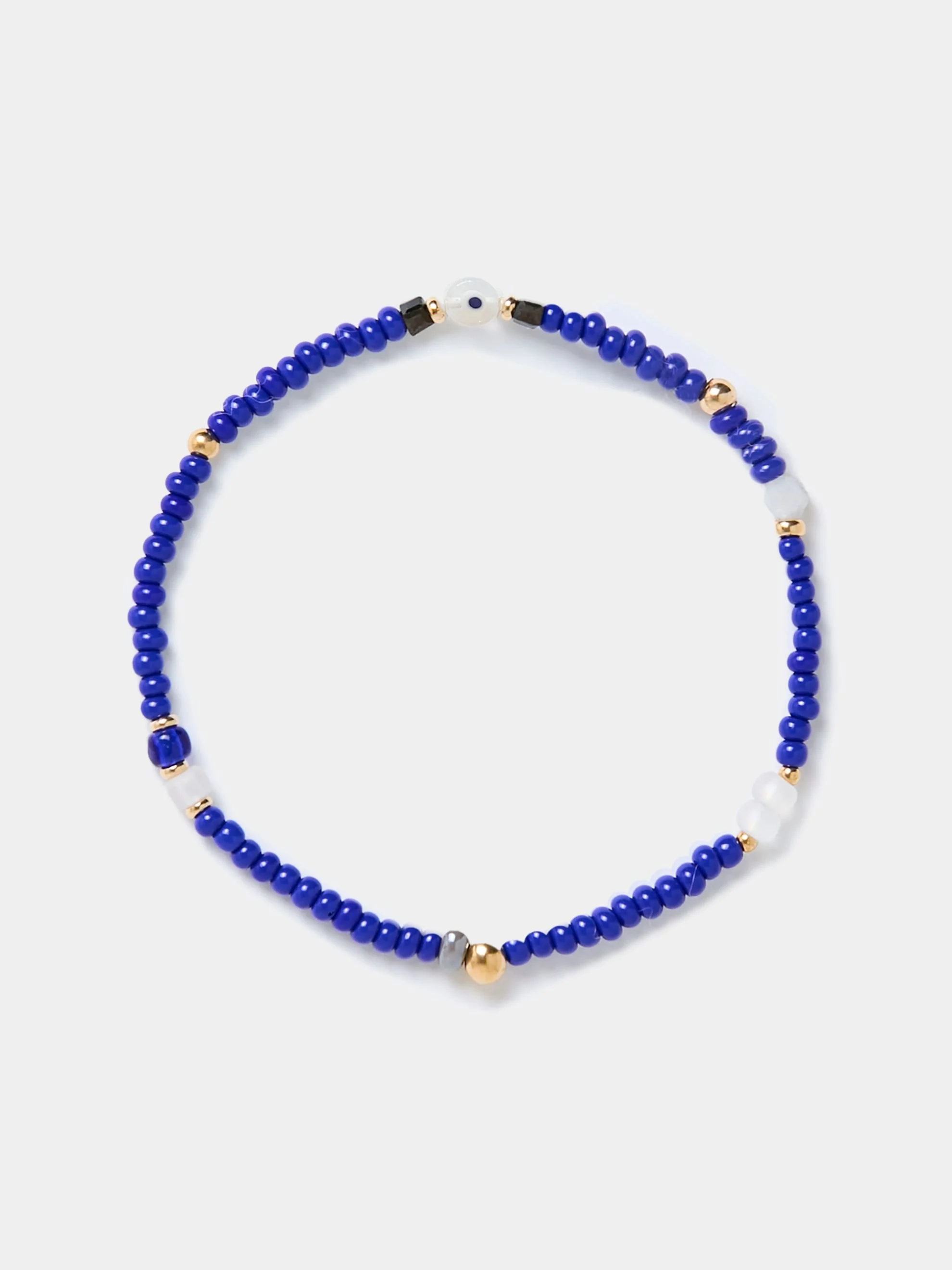 Blue beaded bracelet with small gold, black, white, and gray beads on a white background.