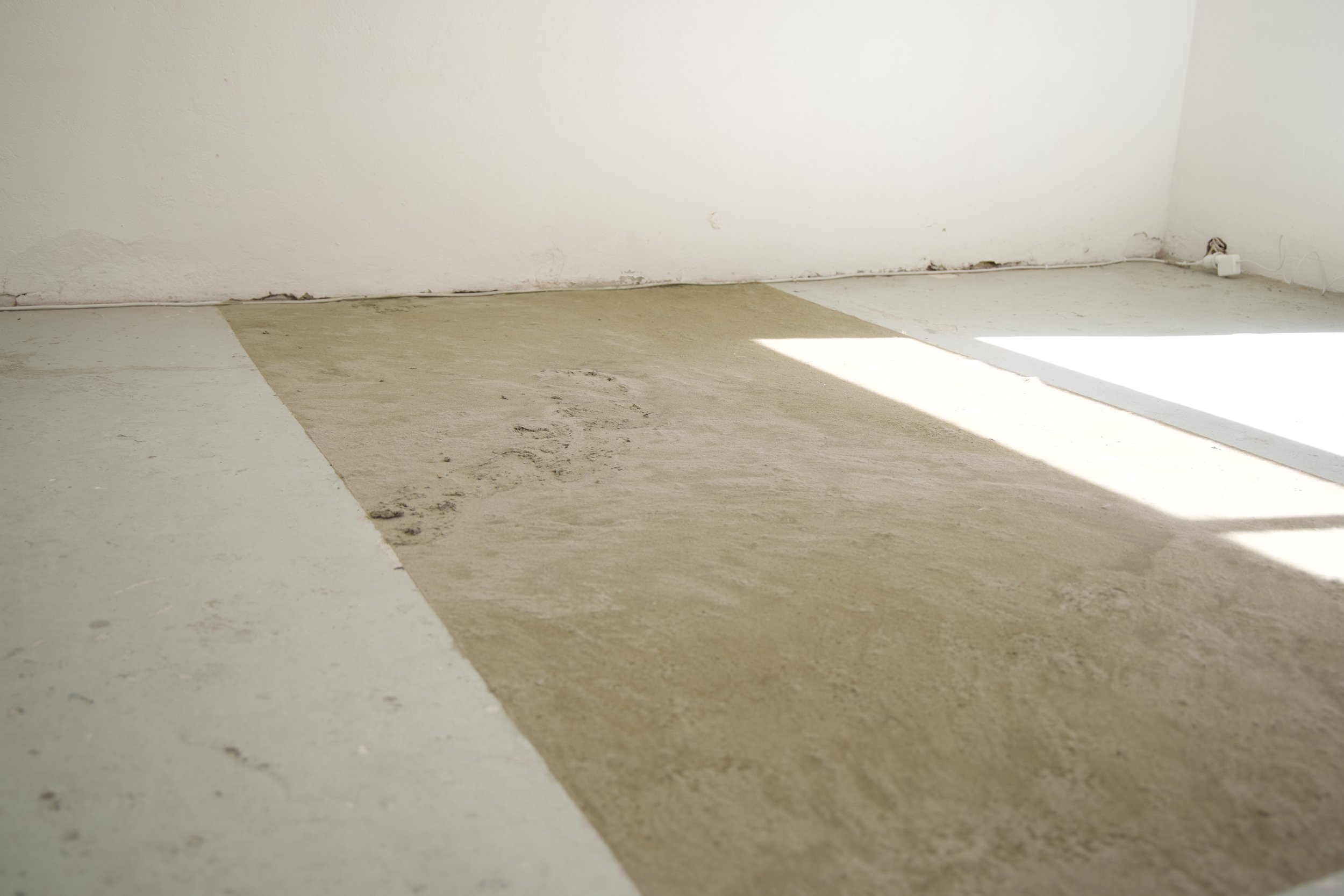 'Tender ground' (installation view), 2025
Site-specific installation. 
Found and discarded materials (cement mortar, acrylic lacquer, PVA).
201 x 145cm. 
Photo courtesy of Puzzle Gallery, Chippendale
