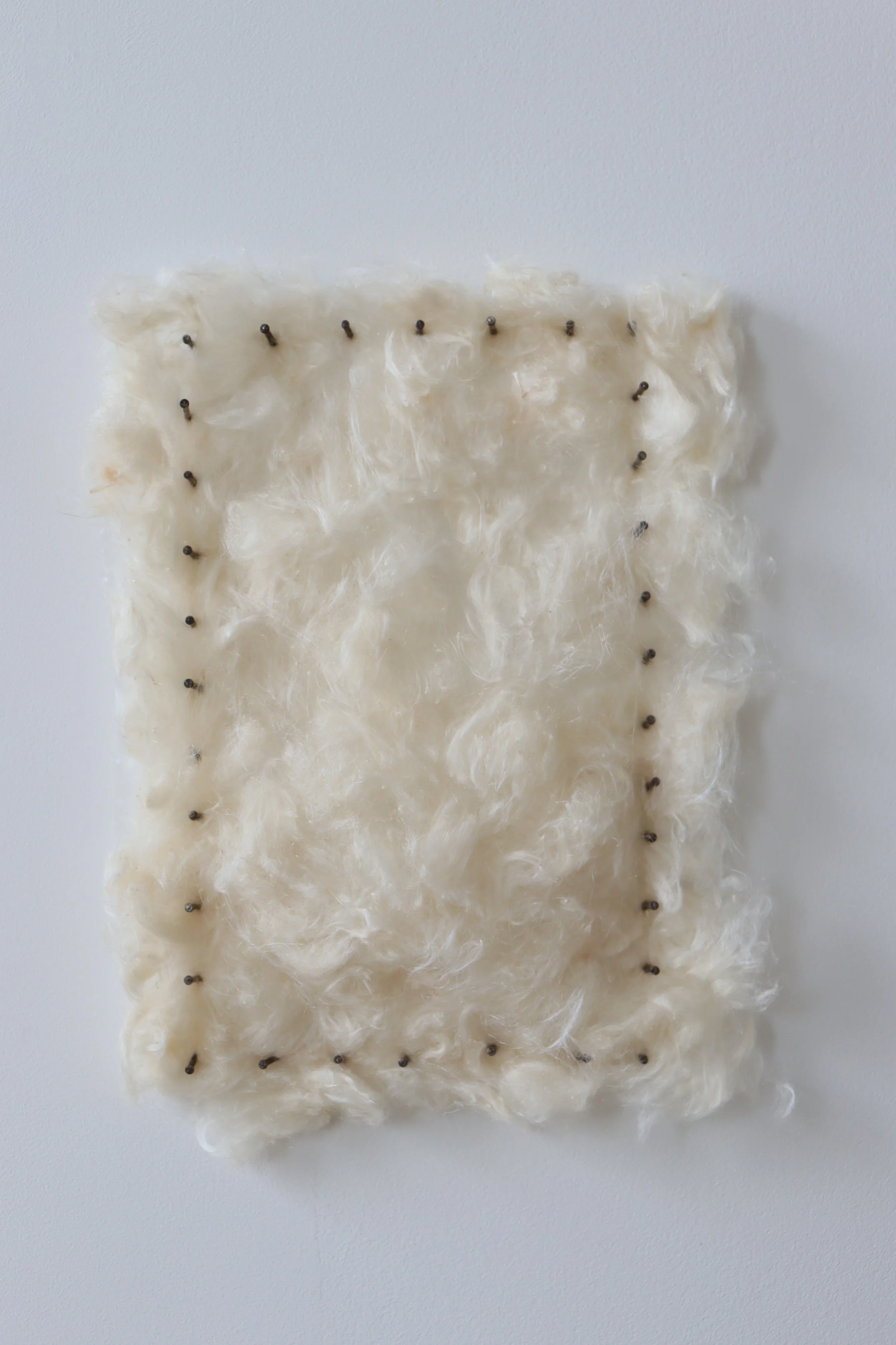 ‘Caught breath’, 2025
Seed fibrils found beneath a woven fence, industrially-crafted silk fabric, hand spun silk and discarded nails.
28 x 21cm