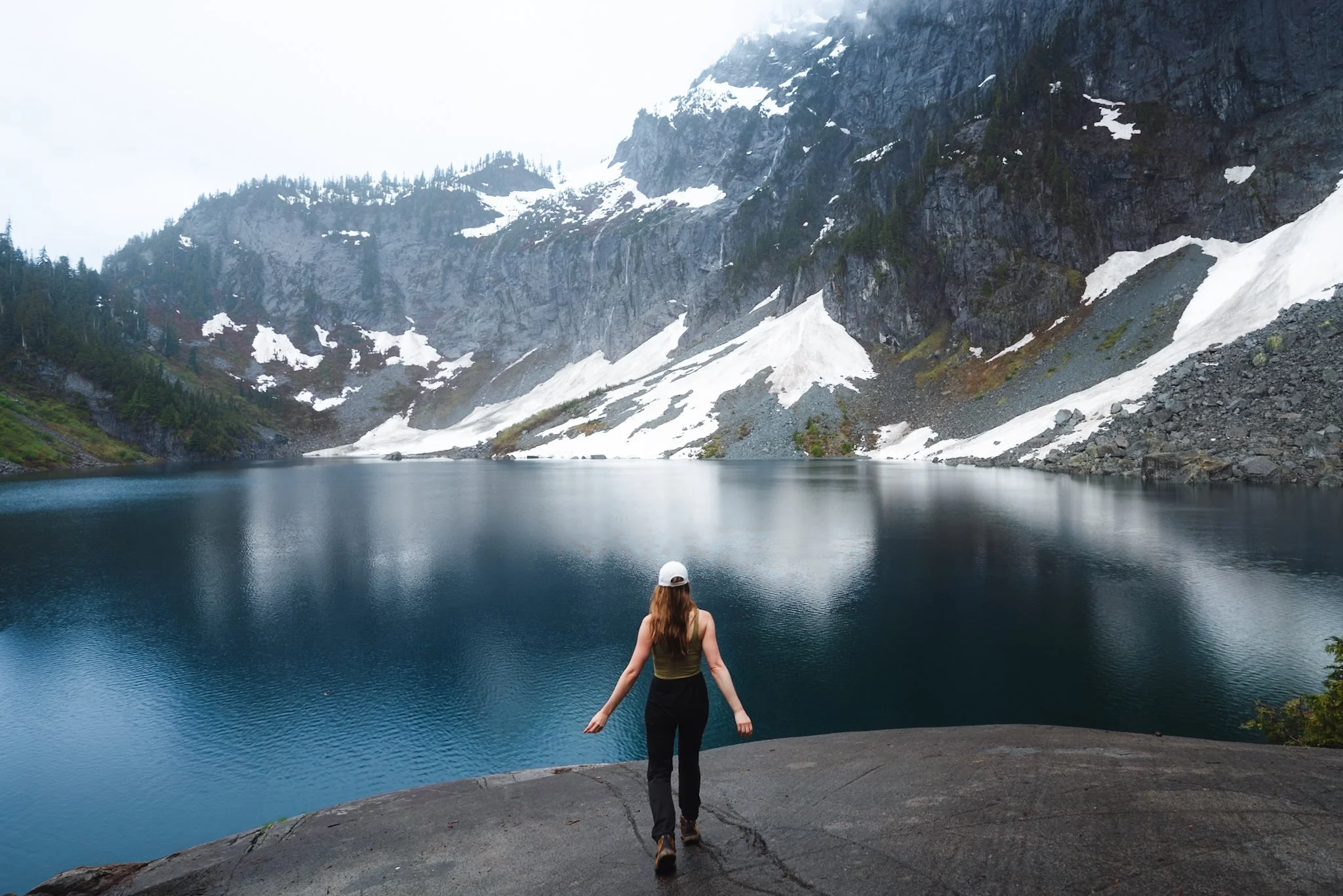 Erin hiking in women's hiking pants Arc'teryx gamma pants in Washington's Cascades mountains near an alpine lake.
