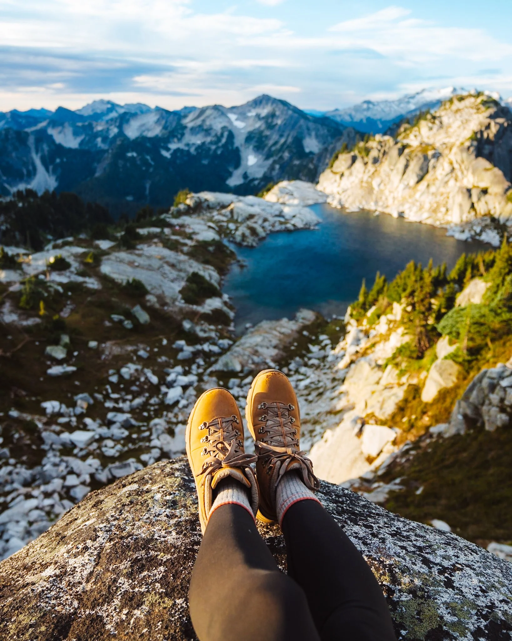 Wearing women’s hiking boots on a rocky alpine lake trail in Washington’s cascade mountains