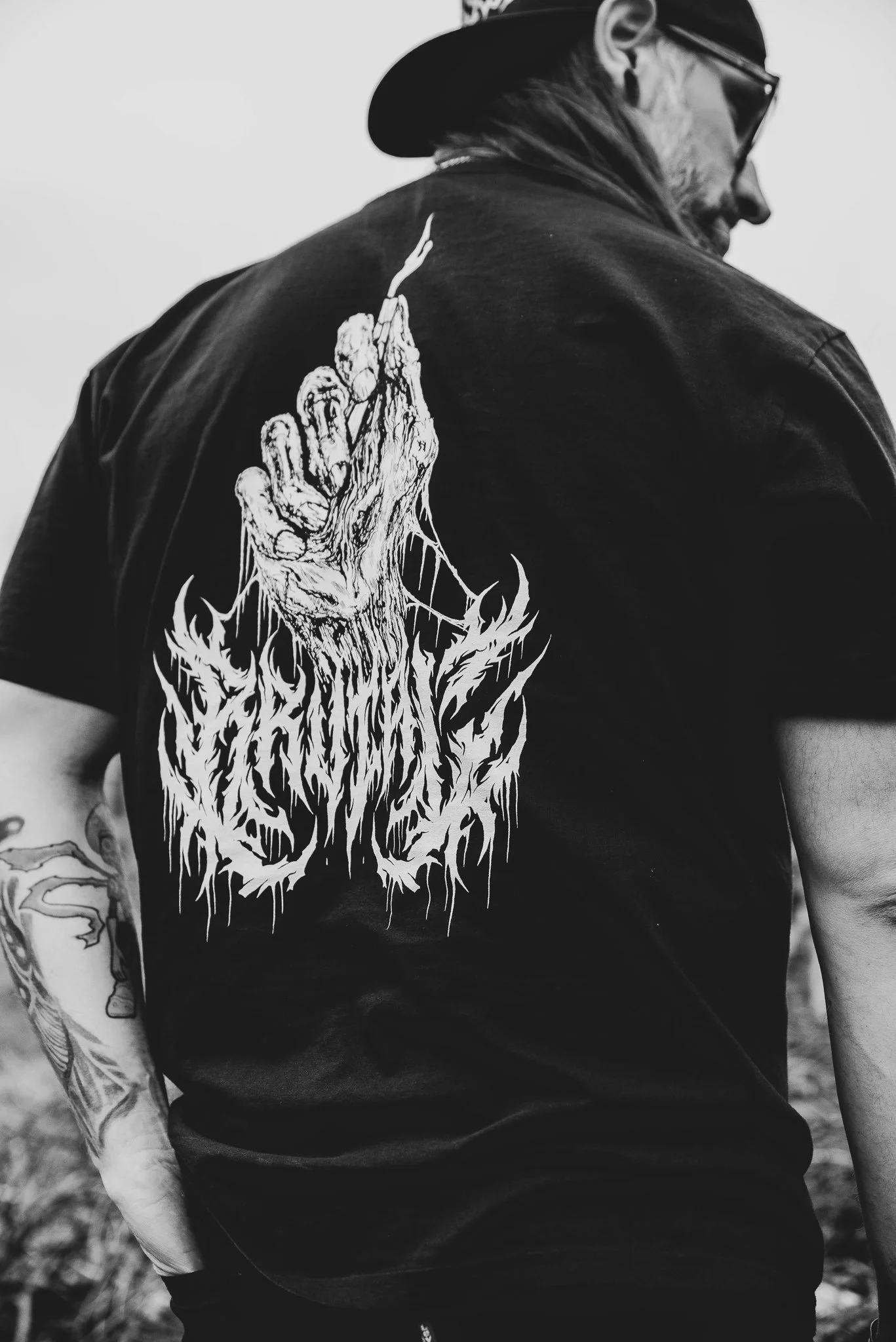 Joshua creator of Cross Stitch and Cambria wearing new BRUTAL merch line